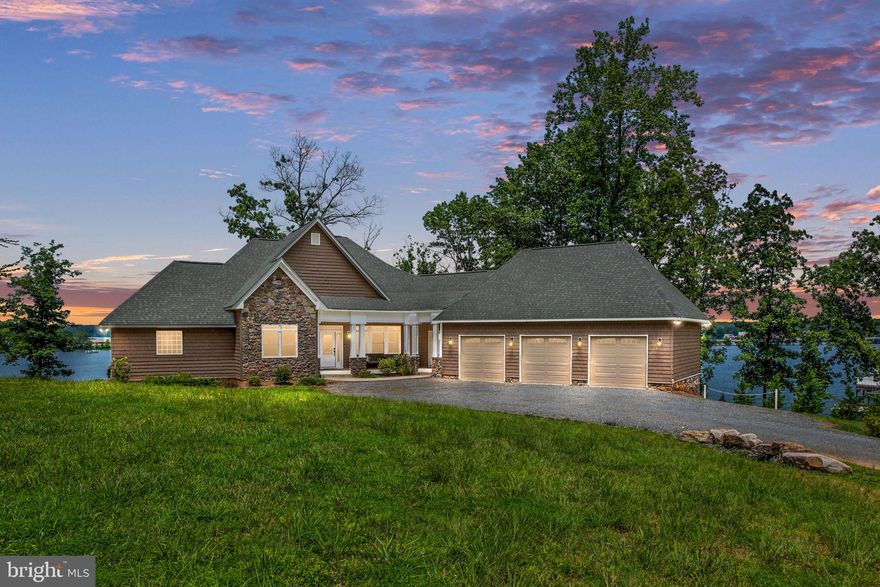 This beautiful home has big water views of the public-side of Lake Anna! The open floor plan makes entertaining simple. There is ample seating both indoors and outdoors, all of which overlook the lake. The main level has the primary bedroom, which overlooks the lake, and primary bedroom, a guest bedroom with guest bathroom, the living room, dining room, kitchen, and laundry room. On the lake level, there are three additional bedrooms, two of which have sliding glass doors to the patio overlooking the lake. The lake level also has a separate living room, game room, and wet bar. Check out that boathouse! This massive boathouse has space for everyone. Sun on the dock, access your boats, jet skis, and lake toys from the lower level. Entertain guests on the upper deck. Enjoy a sunset by the lake around your fire pit. There's something for everyone at this house. Schedule your showing today.