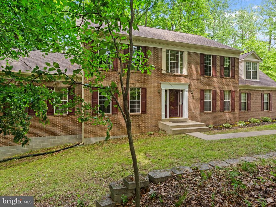 Spacious updates, privacy, and luxury amenities come together in this exceptional brick colonial situated on a serene and private 1.27-acre lot surrounded by nature, yet just minutes from everything. This stunning 5-bedroom, 4.5-bath home features extensive recent improvements including a new roof, new dual-zone HVAC systems, updated primary bathroom, new flooring throughout on all three levels, fresh designer paint, and whole-house wiring for a backup generator.

The bright open floor plan offers an inviting eat-in kitchen with stainless steel appliances, center island, and abundant natural light flowing seamlessly into the spacious family room with fireplace and the gorgeous skylit sunroom. Step outside to the expansive deck overlooking peaceful wooded views — the perfect setting for entertaining or relaxing in total privacy.

The fully finished lower level is designed for both comfort and entertainment, featuring a recreation room, media room with projector, private spa area with Jacuzzi and sauna, plus plenty of flexible living space. A side-load garage, generous room sizes, and meticulous maintenance throughout make this home truly move-in ready.

Ideally located with easy access to Andrews AFB, National Harbor, Washington DC, Baltimore, Virginia, I-95, and Route 4, this extraordinary property offers the perfect combination of luxury, convenience, and tranquility. A rare opportunity you do not want to miss!