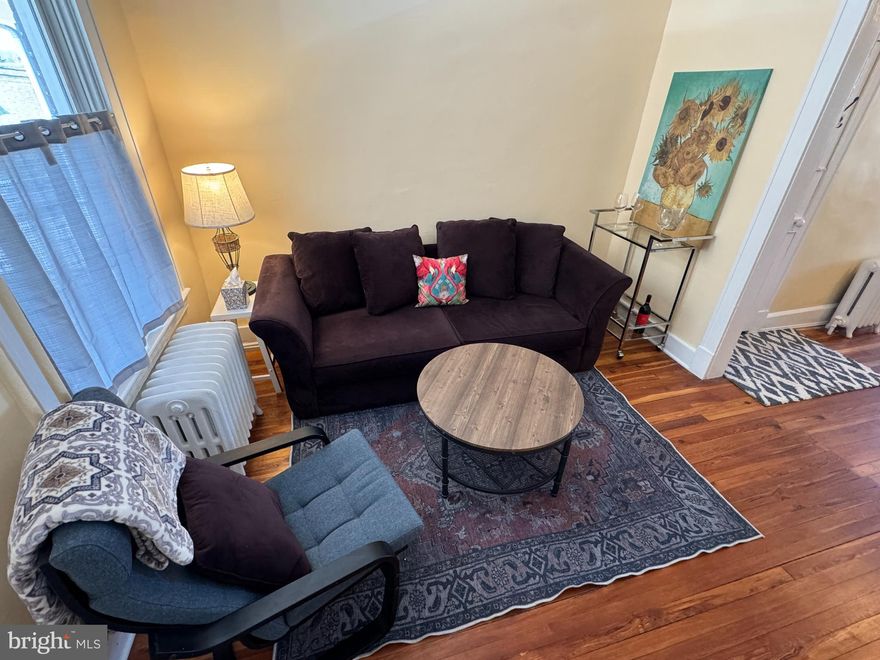 Welcome to 1212 Cox St in HOT HAMPDEN, Hon - where charm meets cool! This updated townhome, located on a sleepy street but in the middle of ALL the action, will definitely check ALL of your boxes! A lot of homes claim to have "gleaming hardwoods"... 1212 Cox St literally wrote the book on them! You HAVE to see this home for yourself! In addition to the original hardwood floors, this Baltimore rowhome touts a newly renovated kitchen AND full bath with the perfect blend of old-soul character and modern-day livability. The finished lower level with a private entrance is the bonus you didn't know you needed  - 3rd bedroom, home office, creative studio, guest suite, or income-producing rental potential. This one has been lovingly cared for by the same owner for nearly 20 years (new roof & gutters 2022, roof recoated 2024, boiler serviced 2024, deck sealed 2025). Sip your morning coffee on the front porch while the neighborhood wakes up around you, or wind down with dinner al fresco as the Hampden energy hums outside. A stone's throw (or toilet bowl race - whatever suits your fancy) from the legendary "Avenue" (36th St) - home to boutique shops, legendary eateries, craft coffee shops, live music, comedy clubs, and the dining scene that keeps putting Hampden on national "best neighborhoods" lists. Light rail access is a short stroll away, making a car-free lifestyle totally doable. Nature lovers will love the proximity to neighborhood parks (Wyman,  Roosevelt, 41st St, etc.), Stony Run Trail and Druid Hill Park - | 2 beds | 1 bath | Hampden | Baltimore MD 21211 | Row Home | Hardwood Floors | Renovated Kitchen | Finished Basement | Private Entrance | Light Rail | Walkable | Move-In Ready | 36th Street | Historic Baltimore | Urban Living