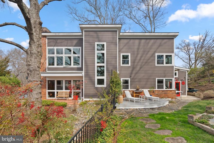 This 5-bedroom, 3.5-bathroom home offers a blend of mid-century modern design and contemporary features, thanks to a 2011 expansion and renovation by Art Design Build. It truly has everything today's buyers are looking for!
As you enter, you're greeted by a stunning, architecturally designed two-story foyer with many windows that flows into a spacious living and dining area. This space features a cozy fireplace, hardwood floors, architecturally significant windows, plantation shutters, a powder bath, and double doors leading to one of the many outdoor patios. The modern, sky-lit kitchen is equipped with granite countertops, stainless steel appliances including a Wolf 6-burner stove, Bosch dishwasher and microwave drawer, and a large seated island that opens to the family room. The family room also boasts heated slate floors, custom built-ins, a desk, and a wet bar with a separate beverage fridge. Two spacious bedrooms, an office, and a full bath complete the first floor.
The upper floor is accessible via a striking, light-filled staircase with a two-story architectural windows. The primary suite includes an exposed brick wall complemented by a wall of windows offering stunning southwestern views of the yard and landscape. You'll also find a large walk-in closet, built-in storage, and a primary bath with a double sink, custom cabinets, a separate shower, sky-lit vaulted ceilings, and a soaking tub. Two additional bedrooms, a full bath, a separate laundry room with a laundry sink, and attic storage access complete the upper level.
Outside, the current owners have created perfect outdoor spaces with extensive landscaping, hardscaping, and outdoor lighting. Several patios, a deck, and a firepit area provide outdoor gathering spots for year-round enjoyment. A PRIVATE GATE PROVIDES ACCESS TO THE HUGE YARD AT THE BANNOCKBURN CLUBHOUSE - tons of play space wihtout having to maintain the grass. Additionally, there’s an attached workshop area with separate heating and cooling, suitable for a multitude of uses such as a woodshop, yoga or art studio, a "man-cave or she-shed," or simply additional storage.
Current owners park on street; however it is possible to install a curbcut & parking pad should new owners desire off-street parking.
Located in the highly desired Bannockburn neighborhood, you'll enjoy the annual Music Festival, Bannockburn Swim Club, Bannockburn Clubhouse, and easy access to Glen Echo Park, the C&O Canal, the Potomac River, numerous nature trails, and Cabin John Park just across the Union Arch Bridge. With a quick commute to DC, VA, or Bethesda, and access to I-495, the location is unbeatable in the Bannockburn, Pyle & Whitman school district.