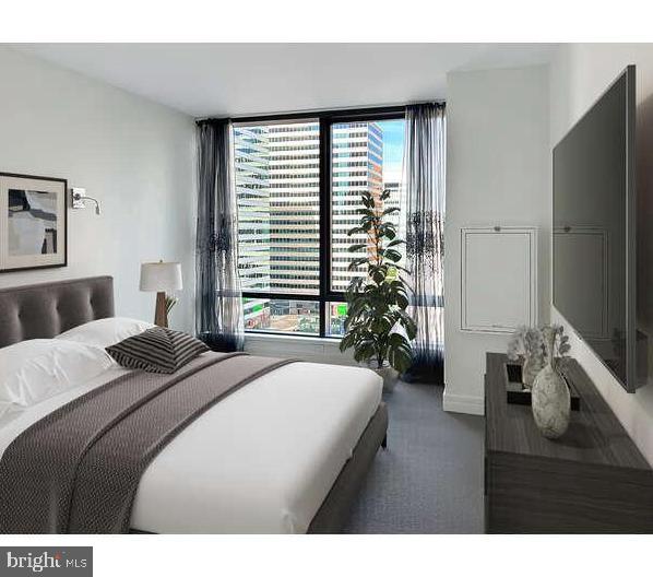 Ritz Carlton Residences Unit 10E INCLUDES A LICENSED ON-SITE PARKING SPOT. This unit has floor to ceiling windows that offer stunning views of City Hall and Dilworth Plaza. This spacious 1 bedroom 1 1/2 bath home is in Philadelphia’s Premier Address and has luxurious black wood kitchen cabinets, large stone island with room for barstools, beautiful hardwood cherry floors and upgraded carpet in the bedroom. Primary bedroom has abundant light and a large walk-in closet and a second sizable closet. Closets were professionally designed. Primary bathroom has Calcutta marble with a frameless shower, separate deep soaking tub and double sinks. Original washer and dryer was replaced with full size Speed Queen units. The gourmet kitchen comes with a Sub Zero refrigerator, Viking Range, Viking Microwave, Miele Dishwasher and U-Line Wine Cooler. Some photos are virtually staged.
AMENITIES: 24 hour Concierge, Door Attendant, Chauffer driven S Class Mercedes Benz and covered access to private outdoor park with waterfall and residents entrance to the Ritz Carlton Hotel. Hotel offers residents 24 hour room service, and in room dining. On-site private dog park, newly renovated Residents Lounge and balcony, media room, and caterer’s kitchen. Don’t want to host in your home? Resident’s lounge can be reserved and used for business meetings or personal gatherings. 7,000 square foot fitness center which includes a lap pool, hot tub, yoga/pilates room. Pet walking, baby-sitting services, dry cleaning and on-site storage units available for an additional fee.
RITZ RESIDENT PERK: Residence Owners receive a guaranteed room rate discount at Marriot’s portfolio of luxury brand hotels (Ritz, Bulgari, Edition, JW Marriott, etc) as well as a complement of various amenities and services during your stay.