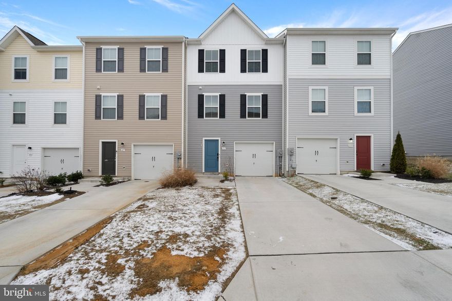 Skip the wait on new construction—this beautiful 3-bedroom, 2.5-bath townhome, built in 2022, is move-in ready and packed with tons of great features. Enjoy an open layout with over 1,800 sq ft of living space. The kitchen offers an enormous center island, pendent lights, backsplash, granite counters and stainless-steel appliances. Off the rear of the property is a large 17x9 maintenance free composite deck, perfect for entertaining. The entire main level is outfitted with easy maintenance-free LVP flooring as well as all the bathrooms and entryway. The spacious primary bedroom upstairs offers a large walk-in closet, and connecting bath with granite counters, wall sconces, and a walk-in shower.  The entry-level rec room offers flexible space for a home office, gym, or playroom, and walks out to the backyard.  Located close to schools, shopping, and commuter routes in a welcoming community with low HOA fees.  Some photos are virtually staged.