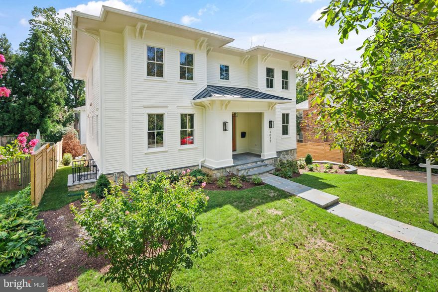 An architectural triumph in Washington, DC’s prestigious Kent/Palisades enclave, this exceptional detached residence by CIMA Design and Build redefines refined city living. Seamlessly blending sophistication with modern luxury, the home offers over 5,600 square feet of thoughtfully curated design, perfectly positioned within one of the city’s most coveted neighborhoods. A grand entry welcomes you into a stunning interior highlighted by soaring 10-foot ceilings, a sun-drenched open floor plan, and impeccable finishes throughout. Custom designer moldings and wide-plank white oak hardwood floors create a timeless foundation, while expansive living and entertaining spaces flow effortlessly—ideal for both elegant gatherings and everyday living. Natural light pours through strategically placed windows, illuminating every exquisite detail.  At the heart of the home, the chef’s kitchen is a true showpiece, appointed with top-of-the-line Thermador appliances, a dramatic waterfall island, and a fully equipped butler’s pantry featuring a second dishwasher—perfect for seamless entertaining. Integrated whole-home audio enhances the ambiance, whether hosting lively celebrations or enjoying quiet evenings in.  The upper level offers a luxurious private retreat in the primary suite, complete with heated floors, a spa-inspired bath with a skylit soaking tub, and dual custom walk-in closets. Three additional spacious en-suite bedrooms and a conveniently located laundry room provide both comfort and functionality.  The light-filled lower level, with impressive 9-foot ceilings, offers exceptional versatility. Featuring two additional bedrooms, a stylish wet bar with beverage refrigerator, and direct walkout access to the backyard, this level is ideal for guests, recreation, or extended living.  Outdoors, a beautifully designed oasis awaits. The expansive patio, built-in grill, and integrated speakers create the perfect setting for alfresco dining, entertaining, or peaceful relaxation surrounded by lush landscaping.  Additional highlights include an oversized attached two-car garage with EV-charging readiness, a thoughtfully designed mudroom with custom built-ins, CAT6 wiring, a comprehensive security system, fire sprinkler system, and abundant storage throughout.  Ideally located, this remarkable residence offers effortless access to Georgetown, Downtown DC, McLean, Arlington, and Bethesda, along with close proximity to acclaimed dining, boutique shopping, and the scenic trails of the C&O Canal.