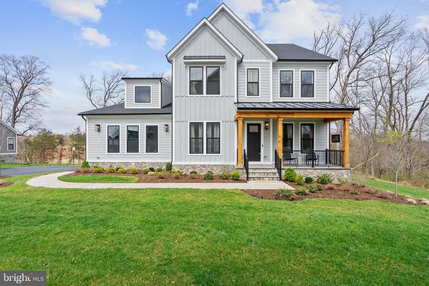 Welcome home to Hartland, one of the most sought-after communities in Aldie. This exquisite like-new home backs to a protected preserve with a stream. The private, rear deck, complete with three-season screened porch, fan, and stairs to the lower level, takes full advantage of the unique views and natural setting. Inside, this home has numerous custom touches throughout including accent walls, custom lighting, designer tile, and much more. The main level has a formal living room with French doors, formal dining, gourmet kitchen with tons of upgrades, a wet bar/butlers pantry, a dry bar/coffee bar, family and breakfast rooms, enormous pantry, mudroom, and a private rear office. Up the wood stairs you find the primary suite with coffer ceiling, two walk-in closets, and in the bath- marble tile, a separate tub, double vanities, and a huge frameless shower with bench and dual heads. The dedicated laundry room with sink and the three over-sized bedrooms- one ensuite and two with Jack-and-Jill bath- complete the upper level. The basement has Two bedrooms, a full bath, a rough for a second full bath, and a huge finished open area for any layout you want. There is also a rough for a wet/bar and for a second laundry room. Additional upgrades include a water filtration system,  a fully stone-wrapped foundation, and EV Charger in the garage. HOA fees include all of the Hartland amenities, including Verizon gig-speed internet, lifestyle programming and events, maintenance and landscaping of common areas, and trash/recycling pickup. The amenities also feature an outdoor pool, fitness center, multiple sports courts/fields, a winery, and numerous walking trails. Hartland is a unique neighborhood that provides its residents with unparalleled living.