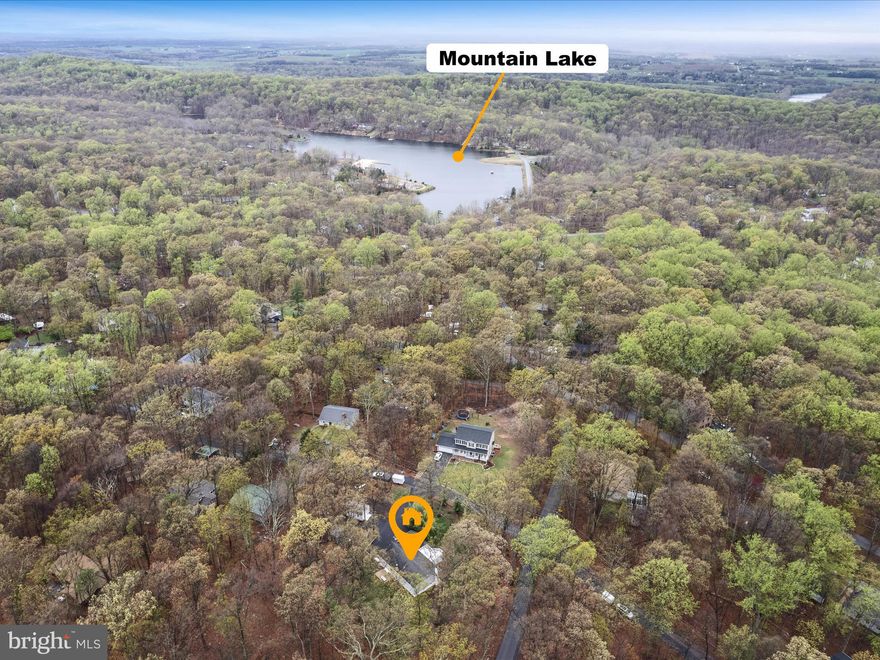 Wake up to birdsong on nearly an acre in the rolling hills of the Shannondale neighborhood. This four-bedroom, three-bath rancher sits on four adjoining lots, offering the privacy of a mini homestead with room to grow. The fenced backyard is ready for chickens, gardens, or gathering with friends around a firepit.

Inside, the vaulted living room features hardwood floors, a bay window, and a wood-burning stone fireplace—a cozy focal point for fall and winter nights. It flows into a light-filled dining area and an open kitchen, with a walk-in pantry conveniently located at the top of the spiral staircase. The main level also includes a peaceful primary suite with ensuite bath, two additional bedrooms, and a second full bath.

Downstairs, the walk-out lower level offers flexible finished space: a hobby studio, family room with wood stove, fourth bedroom, third full bath, laundry area, and plenty of storage. An attached one-car garage keeps daily life easy, while the 12×20 detached garage/workshop offers space for projects, tools, or toys. A freshly paved driveway adds plenty of parking.

Just minutes from commuter routes, the Shenandoah River, and Lake Shannondale, this property delivers a blend of rural charm and modern convenience. Whether you're dreaming of a homestead, farmette, or micro-farm, or just more breathing room, 282 Rolling Lane is your chance to live a little freer.