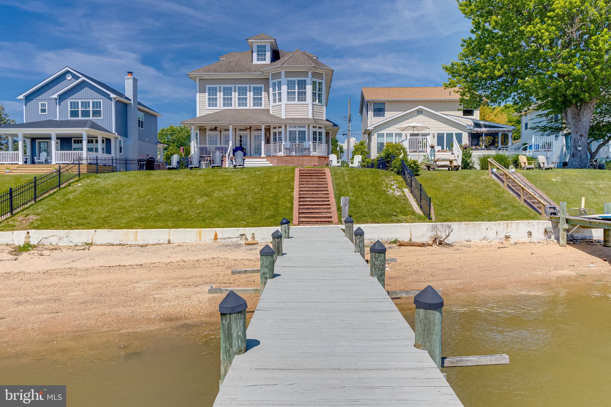 Waterfront Paradise Awaits at 717 Rockaway Beach Ave.
Immerse yourself in unparalleled waterfront living in this exquisite 4-level home boasting breathtaking views. Unwind in the open floor plan designed for seamless entertaining, featuring custom cabinetry throughout and a stunning full bar area on the main level.
Prepare culinary masterpieces in the gourmet chef's kitchen adorned with Viking commercial appliances, a Sub-Zero refrigerator, a built-in microwave island with a mini-fridge, and a spacious dining area – all while gazing out at the water.
Retreat to the luxurious primary suite featuring a hotel style en-suite with double vanities, a soaking tub, and a spacious walk-in shower. Unwind after a day on the water in this haven, complete with a custom barn door on the bedroom level laundry area and built-in shelving units for ultimate organization.
Every oversized bedroom in this home offers a tranquil escape, with high ceilings and natural luxury creating a full experience of privacy and sense of home. The finished lower level expands your entertaining area, featuring a second full kitchen, a full bathroom, pool table, and entertainment equipment needed.
Step outside to your private oasis and enjoy the true joy of waterfront living! Relax on your private beach, launch your kayak or boat from the pier with a lift included, or simply take in the sunrise and set from the furnished patio. This immaculate home comes furnished, allowing you to move right in and start creating lasting memories. Don't miss this opportunity to own a piece of waterfront paradise!