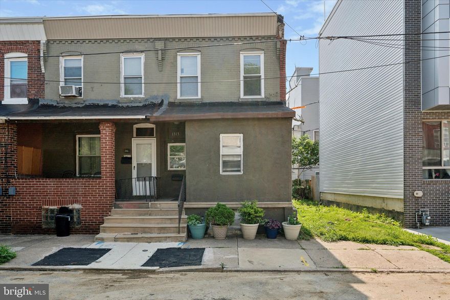 Check out this well-appointed end-of-row townhouse offering a smart layout, modern updates, and a quiet spot in the heart of Grays Ferry! You’re greeted by a classic brick-accented façade and a covered front porch, perfect for morning coffee or relaxing evenings. Step inside to an enclosed foyer that opens to a bright and spacious living room featuring recessed lighting and striking hardwood floors that flow throughout the entire home. In the rear, the updated eat-in kitchen impresses with a center island with bar seating, sleek black appliances, ample quartz countertop space, and plenty of upper and lower cabinets. Door leads to a private rear patio, offering a blank canvas for your own outdoor retreat. Upstairs, you’ll find two generously sized bedrooms, each with its own private ensuite full bathroom. The unfinished basement houses the laundry area and offers plenty of practical storage space, it's bare and waiting for your personal touch to finish and transform. On-street parking is available. Located in Grays Ferry, this home is just a short drive to University City, Center City, major highways, and public transportation options, making commuting and daily errands a breeze!