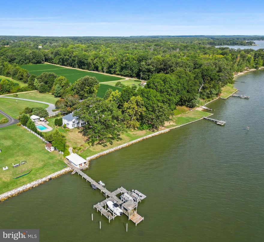 Imagine waking up every day to the serene sounds of the water, stepping onto your second-story balcony, and soaking in the natural beauty that surrounds you. Welcome to your dream home—a breathtaking 4-bedroom, 4-bath waterfront property that offers 3,024 square feet of beautiful living space on a sprawling 1.9-acre lot. Located just 90 minutes from Washington, DC, this home is a perfect retreat for those who value beauty, tranquility, and convenience. Crafted with attention to detail and love, this home offers so many amenities.  

Exceptional Living Spaces
Step inside to a spacious design that seamlessly blends comfort with elegance. The large windows throughout the home not only provide spectacular views of the water but also flood the interior with natural light, creating a warm and inviting atmosphere year-round. The  kitchen is equipped with modern appliances, ample counter space, and custom cabinetry, opening up to a small dining area and living room, full size dining room, making it perfect for entertaining family and friends.  The living room is complete with a wood burning fireplace, ideal for chilly winter evenings. One of the unique features of this property is the additional spaces it offers. A bunkhouse or guest space provides plenty of room for visitors or extended family. This added convenience means you can entertain without compromising your and your guest’s privacy. 
Unmatched Outdoor Amenities
The outdoor features of this property are nothing short of spectacular. The in-ground heated saltwater pool comes equipped with an automatic cover for ease and safety; a pool house adds to the convenience. You will also find an outdoor shower that's perfect for rinsing off after a refreshing swim. The property also includes a boathouse and dock outfitted with three functioning lifts—ideal for your boat, jet ski, and kayaks. A screened porch, outdoor fireplace, and built in green egg make this home perfect for entertaining guests in style. Imagine the serenity of picking fresh fruit from the sickle pear trees, peach trees, and fig trees that adorn the landscape. An irrigation system ensures that your beautiful garden remains lush and vibrant.
Recent Renovations and Upgrades
In 2013, major renovations and upgrades were made. The roof was replaced, and both HVAC systems were replaced to ensure efficient and reliable climate control. The kitchen and bathrooms have been remodeled. Enjoy the comfort of newly replaced living room and upstairs TV room windows and doors. The inside fireplace was rebuilt into a stunning wood-burning fireplace with a gas starter, adding both charm and functionality.
Enhanced Outdoor Living
A porch area was screeded adding an additional outdoor dining area. The outdoor poolside patio was replaced and enlarged, offering plenty of space for lounging and socializing. New installations include a pool heater and pump.
The landscaping around the house and pool has been completely refreshed, ensuring that the outdoor space is as stunning as the indoors. Additionally, the wall and walkway from the yard to the boathouse have been remodeled for ease and aesthetics. Low voltage landscape lighting creates a magical ambiance in the evenings, highlighting the beauty of your surroundings. 
Energy Efficiency and Comfort
To add another layer of comfort and efficiency, additional insulation was installed under all roofs three years ago. The crawl space has also been meticulously encapsulated, making the home’s energy use more efficient.

Additional outbuildings include large detached garage with ample space for cars, tractors, storage.
Don't Miss This Opportunity
This waterfront home is a rare find, combining luxury, comfort, and practicality in a tranquil, picturesque setting. Whether you're looking for a serene retreat, a place to entertain, or a family home with plenty of space and amenities, this property has it all. Schedule a visit today and experience the unparalleled lifestyle that awaits.