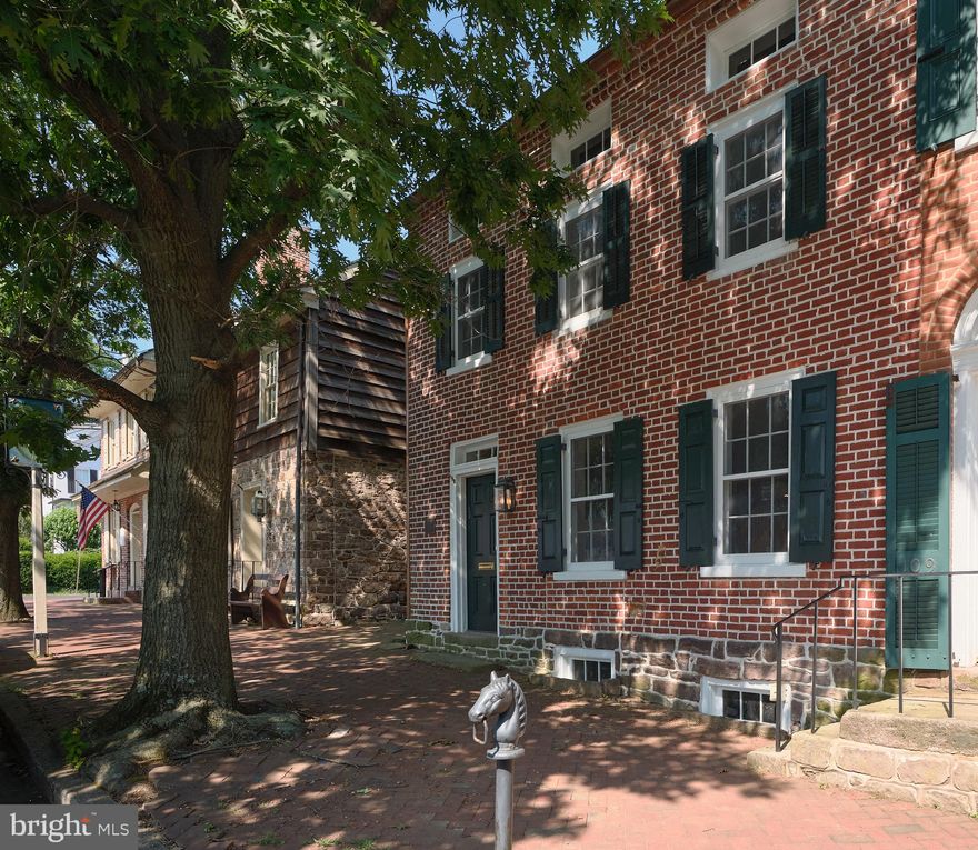 Welcome to the Thornton- Hicks House, a truly remarkable property that seamlessly marries historic charm with modern luxury. This lovingly renovated and expanded home in Newtown Borough boasts a perfect blend of old-world elegance and contemporary convenience. The home was originally built in 1782 by Margaret Thornton, Tavern Keeper of the neighboring Court Inn, and was later passed to Edward Hicks, the famous artist of "Peaceable Kingdom".  The Thornton- Hicks House exudes a rich history that has been preserved through meticulous attention to detail.  Inside you will discover a beautifully designed living space that features a harmonious flow between the living room, dining room, and kitchen. The newly constructed kitchen addition showcases high-end finishes such as quartz counters, Thermador appliances, and a gas range- truly chef's dream!  The first floor also includes a mudroom with custom bench and storage, powder room, and laundry room for added convenience. Sitting at the back of the home is a large, first floor bedroom, complete with vaulted ceilings, en-suite bathroom, and acess via french doors to the 18x16 stone patio. On the second floor, you'll find two charming bedrooms and a full hall bathroom, along with an additional laundry area. The third floor boasts a stunning bedroom with an en-suite bathroom, vaulted ceilings and a large dormer, offering a peaceful retreat with ample natural light. Outside, the property features a private and picturesque setting enhanced by a bluestone walkway leading to an inviting stone patio and a spacious 650 sq. ft garage with parking for 2 cars and additional workspace. Located just steps away from State Street, this home offers the perfect blend of tranquility and accessibility. Experience the best of both worlds at 107 Court Street—where historic elegance meets modern sophistication.
*Photos coming July 15th* 
*Showings Begin July 17th*