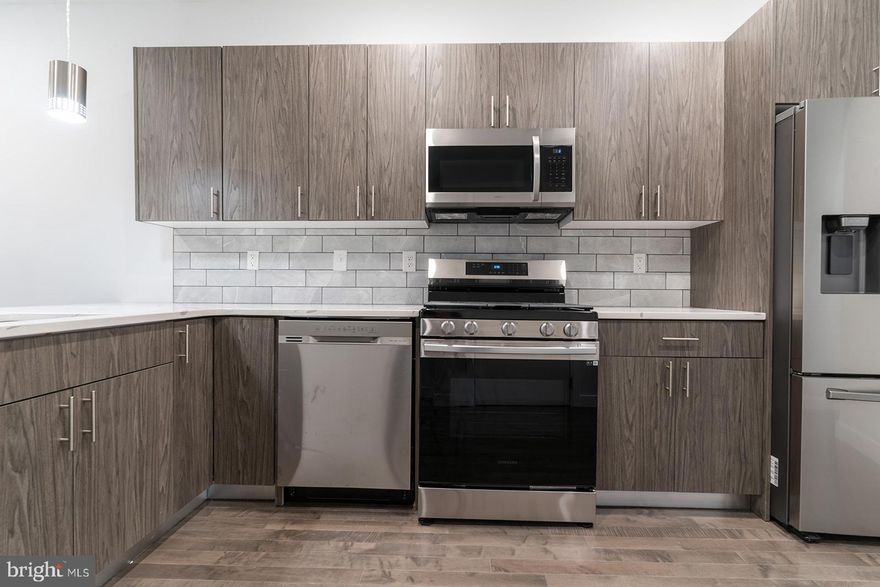 Boasting toasted oak hardwood flooring, fully-loaded kitchens, and central air, 1947 N 7th St #2 comes equipped with everything you need to feel right at home. Upon entry, you are greeted by an open living and dining concept. The room is soaked with sunlight thanks to the oversized windows. Whether you're a Grub Hub gazelle or a meal prep maniac, the kitchen offers stainless steel appliances, driftwood cabinets with brushed nickel hardware, calcutta quartz counter tops, and contemporary pendant lighting to support any culinary lifestyle needs. This flat is offers two functional and sizable bedrooms, each with their own respective full bathrooms and dedicated closet spaces. Washer/dryer in-unit. Recessed lighting throughout. Private intercom system and smart thermostat! $40 application fee per applicant. Generally, first, last, and security are due upon signing. $35 flat water fee per month. Pet-friendly. Walking distance to Temple University, Cousin's Supermarket, Human Robot Beer, Luna Cafe, the Broad Street Line. Easy access to all the happenings in Fishtown, Broad St/611, and Girard Ave.  Available now.