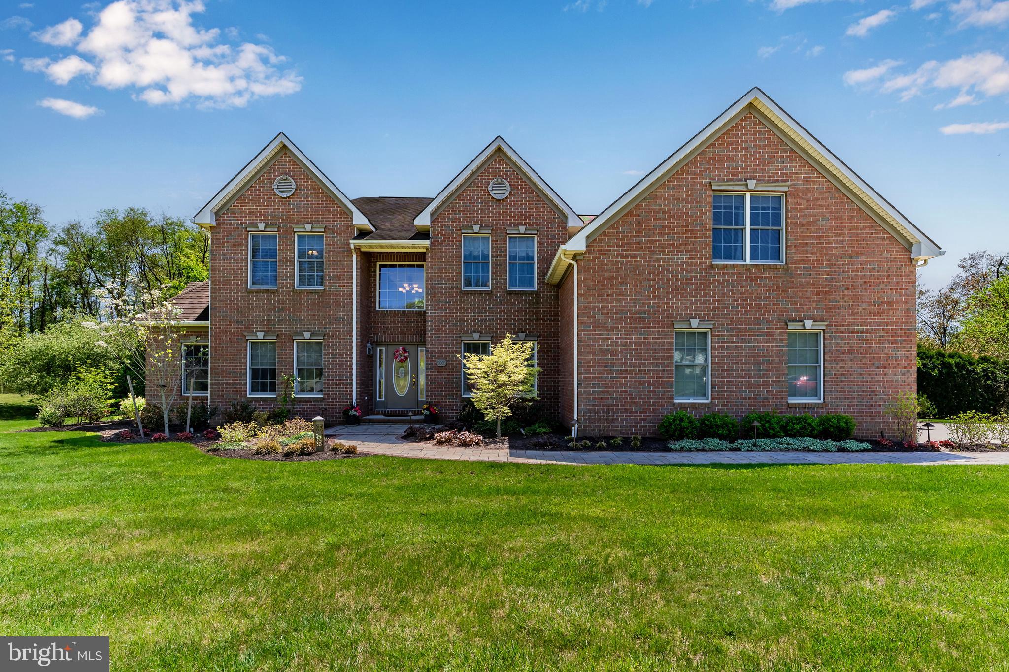 Experience the perfect blend of luxury, comfort, and convenience in this stunning custom residence set on a private, .71-acre lot in the coveted Cumberland Valley School District, just minutes from major expressways and top hospitals. From the moment you arrive, you’ll appreciate the striking curb appeal: a low-maintenance, three-sides brick exterior, a charming paver walkway, and vibrant, meticulously maintained landscaping with both up-and-down lighting. Inside, the home’s thoughtful design and high-end finishes immediately impress. At the heart of the home, the gourmet kitchen showcases professional-grade Thermador stainless steel appliances, an oversized prep island with seating, and a seamless flow into the open-concept family room — ideal for everyday living and effortless entertaining. Extend your living space outdoors into your backyard oasis, fully fenced for privacy and designed for unforgettable gatherings. An expansive patio, built-in pizza oven, two premium JennAir grills, and a whitewashed pergola-covered seating area create the ultimate setting for everything from casual family barbecues to elegant summer soirées. Mature fruit trees add charm and seasonal delights. Your main-floor primary suite is a luxurious retreat, featuring two custom walk-in closets and a spa-inspired en suite bath. Upstairs, discover three generously sized bedrooms, two full baths, and a versatile bonus room — ideal for use as a playroom, teen lounge, media space, or guest quarters/5th bedroom. The fully finished lower level offers exceptional versatility, complete with a sleek wet bar (with sink and dishwasher), a large open entertaining space, a dedicated exercise room with durable rubber flooring, and an additional finished room that could serve as a craft area, playroom, or 6th bedroom if needed. An attached 3-car garage provides ample storage and convenience, while a brand-new HVAC system installed in 2023 ensures peace of mind. With its rare combination of luxury finishes, flexible living spaces, and prime location, this home offers an unmatched lifestyle opportunity. Schedule your private tour today and experience it for yourself!