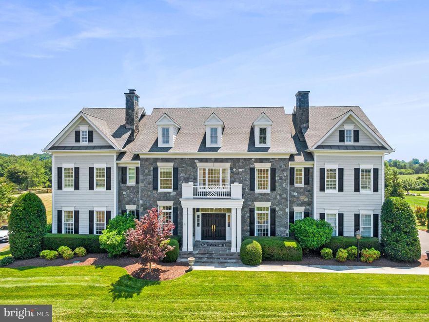 Welcome to your dream home! Nestled on nearly an acre of pristine land, this stunning property offers the perfect blend of luxury, comfort, and breathtaking natural beauty, making it an ideal haven to call home.

As you approach the property, you are greeted by the exquisite stone and hard plank siding, which exudes timeless sophistication. The beautifully manicured front walkway leads to a charming covered front porch, setting the tone for the elegance that awaits inside. The home faces a serene common area, providing additional privacy and a picturesque setting.

The flat, fenced backyard is an outdoor oasis with stunning mountain and scenic views, perfect for family gatherings or peaceful relaxation. The extensive hardscaping includes a patio with a stone firepit, a covered terrace, and a deck with both covered and uncovered areas, seamlessly blending indoor and outdoor living. An in-ground irrigation system ensures the lush landscaping remains vibrant year-round. The 4-car garage provides ample space for vehicles and storage.

Step inside to discover 7" wide plank solid white oak hardwoods that flow throughout the main and upper levels, complemented by extensive and exquisite moldings and graceful archways that add a touch of classic elegance.

The welcoming main foyer entry offers a stunning sightline straight through the home to the backyard views. The home office, perfect for remote work, is conveniently located near the entrance. Formal living and dining rooms, separated by a dual-sided gas fireplace, create the perfect ambiance for entertaining. The butler's pantry, featuring a sink and beverage fridge, connects the dining room to the gourmet chef's kitchen.

The kitchen is a culinary masterpiece, equipped with quartz countertops, a beautiful backsplash, a walk-in pantry, a Wolf built-in microwave and wall oven, a GE Monogram six-burner gas stove with oven, and a side-by-side refrigerator and freezer. Two breakfast bar areas and a center island offer ample seating and workspace. The adjacent breakfast room provides a cozy spot for casual dining.

The family room, located off the kitchen, features a coffered ceiling and a gas fireplace, creating a warm and inviting atmosphere. The main level also offers seamless access to the deck from four different areas: the family room, breakfast room, rear foyer, and mudroom. The mudroom, with a powder room and a cubby and locker system, provides a practical family entrance from the garage.

The upper level hosts the luxurious primary bedroom suite, complete with a vestibule, sitting room, and main sleeping area. His and her walk-in closets offer ample storage, while the primary bathroom boasts a dual sink vanity, soaking tub, and walk-in shower. Four additional bedrooms, each with its own private bathroom, provide comfort and privacy for family members and guests. The conveniently located laundry room adds to the home's practicality.

The lower level is designed for entertainment and relaxation, featuring LVP flooring throughout. The rec room and game room, with a wet bar and seating for three, are perfect for hosting gatherings. A media room offers a cinematic experience at home, while the exercise room caters to your fitness needs. The sixth bedroom, with a private full bathroom, is ideal for guests or extended family. A powder room is available for convenience. Walk-out access to the lower-level patio, firepit, and backyard completes this exceptional space.

Recent Updates include a 50-gallon hot water heater (2024), HVAC for lower level (2023), driveway (2021), roof (2018).

Ideally situated close to Route 15, Route 7, Dulles Access and Toll Roads, downtown Leesburg, Dulles Airport, and local schools, parks, wineries, and breweries, this home offers unparalleled convenience and accessibility.

Discover the perfect blend of luxury, comfort, and breathtaking beauty in this exceptional property. Welcome home!