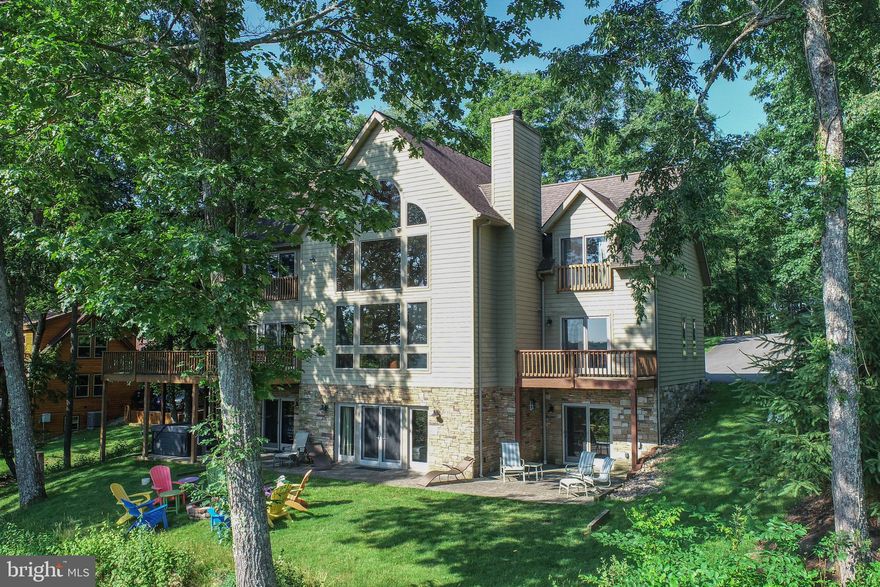 This magnificent home boasts 6 bedrooms, 5.5 baths, an attached oversize garage, AND has a Dock Slip! "Big Chill" is an established rental home and is located in the highly desired neighborhood, Deep Creek Highlands. Subdivision amenities include lake access, an outdoor swimming pool, basketball/tennis courts, and is gated which adds additional privacy. The beautiful outdoor space includes a fire pit, hot tub, and room to enjoy. With 3 levels of finished square footage and many spacious rooms, this house can comfortably accommodate guests. Located right in the heart of Deep Creek Lake, schedule your showing today!