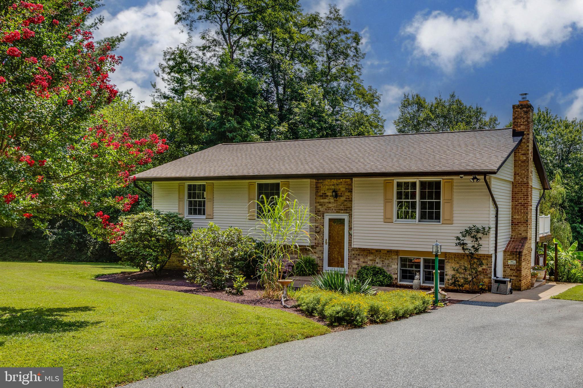 Open House Saturday September 13, 10:00-12:00. Live authentically. Welcome home to your very own private oasis, just steps from Liberty Reservoir. Tucked away at the end of Cockeys Mill Road and sited on a sunny 1 acre lot, this is your quiet retreat to come home to. Stunning stacked stone wall and bright colorful flowers greet you as you pull in. You will instantly feel the beautiful blend of total convenience and complete privacy. Step inside to a happy home filled with sunlight. The open floor plan offers a flexible layout to fit your personal needs. Updated kitchen with new cabinetry and granite counters is the heart of the home, opening to expansive deck which overlooks gorgeous backyard. Main level includes three bedrooms and two full bathrooms. Step downstairs to a walkout lower level with wood stove and walls of windows. Lower level offers versatility with an additional bedroom, full bathrooms and open recreation space. Walk through the slider and step out to a peaceful covered space to relax out of the sun. This is the perfect spot to soak in your personal paradise…the pool, the tiny pond, the greenhouse and the clipping garden of your dreams for a kaleidoscope of colors as your backdrop. Verizon Fios Internet. Cultivate your existence. The art of uniting human and home. Showings to begin Sunday, August 31.