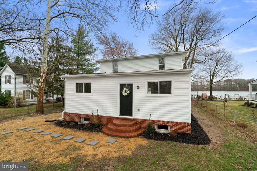 Welcome to a rare waterfront opportunity in Middle River—where peaceful living, beautiful water views, and modern upgrades come together in a newly renovated home that is simply stunning.

Perched on a quiet waterfront side street surrounded by long-time, well-maintained homes, this spacious three-level residence offers beautiful views of the bay and a lifestyle centered around the water. Oversized picture windows fill the home with natural light while capturing sweeping waterfront scenery throughout the day.

The main level features a large kitchen with sweeping water views, a dining room, and a living room designed for gathering and entertaining, along with a main-level bedroom and full bathroom. Upstairs, you’ll find three additional bedrooms—each with water views—and a second full bath. The finished lower level offers a recreation room, laundry area, another full bathroom, and flexible space that could serve as a fifth bedroom, home office, or playroom.

Boating and waterfront living are effortless here with deep water access from your private dock—perfect for kayaking, paddleboarding, crabbing, or heading out by boat to nearby waterfront restaurants like Bowley’s on the Bay.

This home has been extensively renovated down to the studs and fully permitted, offering the feel of a new build with updated electrical, plumbing, HVAC, roof, appliances, flooring, lighting, kitchen, and bathrooms.

An added bonus rarely found in this area: the sale includes TWO tax parcels, creating additional space, privacy, and long-term value. The additional parcel includes a large shed and significantly expands the property footprint.

Set on a large fenced lot with a huge covered patio overlooking the water and a finished basement rarely seen in nearby waterfront homes, this property offers the perfect blend of modern living and relaxed waterfront lifestyle.

Whether you’re looking for a primary residence, weekend getaway, or a home where every day feels like vacation, this is a waterfront opportunity you won’t want to miss.

NEW: 200 amp electrical service, plumbing throughout, HVAC system, roof, appliances, lighting, flooring, carpet, paint, kitchen, bathrooms, finished basement, and some new windows.