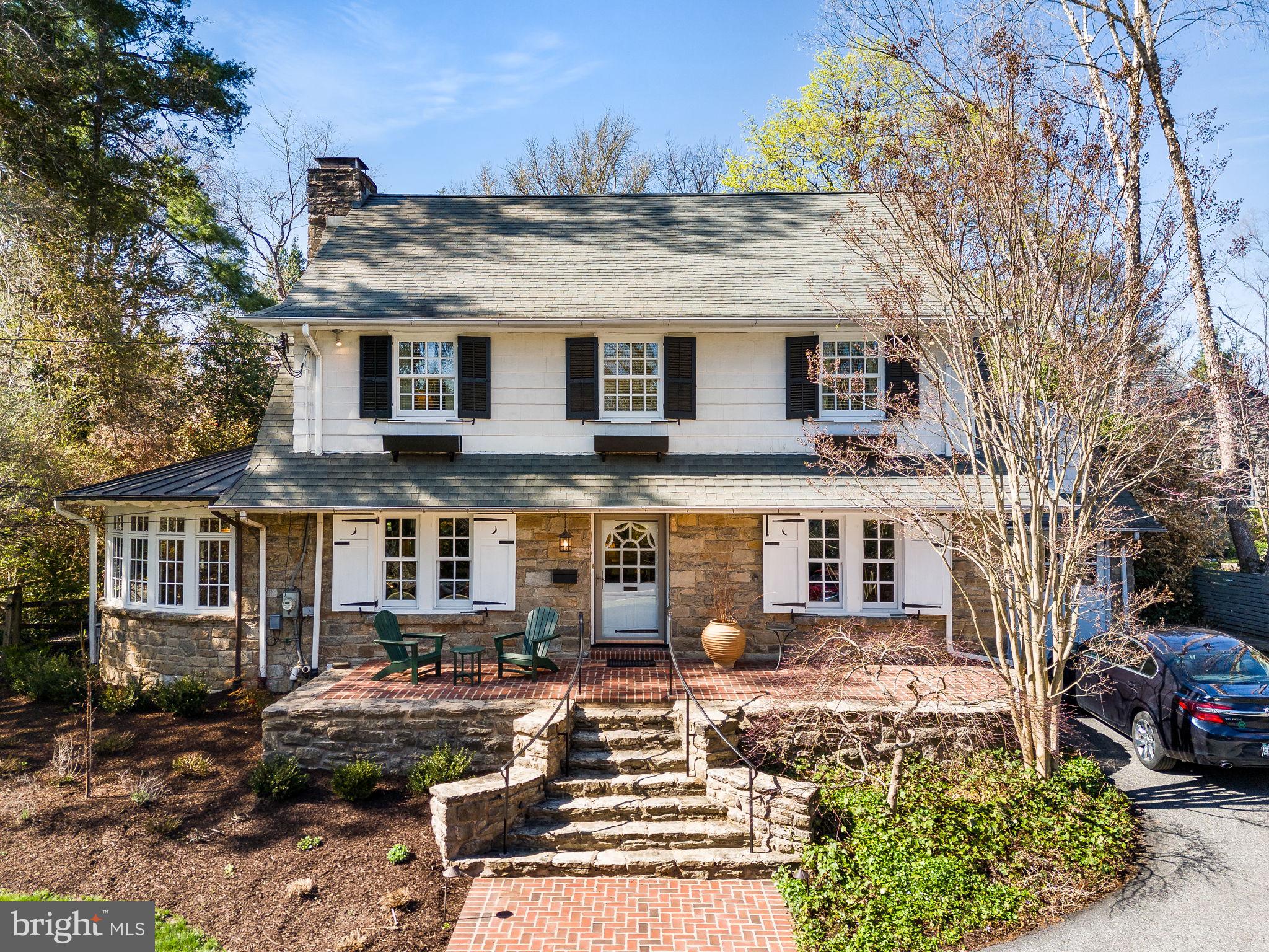 5 Ogden! Oh, what a beautiful home! With a deep front lot (.36acres in total), this classic Swarthmore stone center hall colonial oozes with charm and character. It starts at the front stone steps and brick patio and continues to the formal foyer. The formal living room, off to the left of the foyer, extends front to back, with French doors to the back patio. This room shows off the lovely hardwood flooring that is throughout the home and features an elegantly mantled stone fireplace with original Mercer tiles. You enter a sunroom from either side of the living room fireplace, where a serene, retreat awaits. The entire sunroom curves around a second wood paneled fireplace and mature landscaping outside keeps this room warm and inviting. Finished terracotta flooring adds to the appeal, and there is a seamed copper roof above. Flowing through to the formal dining room on the left of the foyer, notice the deep windowsills, corner hutch and crown molding and entry to the kitchen. The kitchen is a true cook’s joy! A custom paneled refrigerator, stainless wall ovens, gas cooktop and custom tile backsplash make cooking easy. And a large breakfast area sits under a panel of windows to the patio. A fantastic and unexpected mudroom is open to the kitchen and adds so much! Do not miss the hidden laundry chute, potting counter with copper sink, desk, and floor to ceiling cabinetry. There are so many ways to use this space!
The primary bedroom on the second floor has much to offer as well! Flooded with light from the front and back and anchored by custom built in bookcases at either end, this beautiful bedroom includes a small step-down sitting room and spacious ensuite Bath complete with shower, soaking tub, double bowl sinks, custom cabinetry, walk in closet, and the laundry chute to the mud room. This is truly a joy and such a surprise in a home of this age! There are three generously sized secondary bedrooms, one with Hall Bath access.
The third floor includes a finished yoga studio/office/fifth bedroom with skylights and carpet. A large storage room is on this floor as well.
The finished basement is a perfect rec room with a painted floor, storage cabinets, a linen closet and laundry area tucked away behind louvered doors. An unfinished area includes a utility sink and ample shelved and open storage space. NEW gas HVAC, gas hot water.
The tile and flagstone patio is accessed from the living room and mudroom and is terraced, leading up to sheltered dining area under a wisteria pergola. Fencing surrounds the back yard for the family pets. And there is interior access to the garage from the kitchen as well.
With curb appeal abounding, 5 Ogden Avenue enjoys all that Swarthmore has to offer with fair, food truck and parade days so much fun. And, of course, the local shops, public Library, Swim Club, CO-OP grocery store, and train station. Served by prestigious Blue Ribbon Wallingford-Swarthmore schools, you are just twenty minutes from Philadelphia International Airport by car, and thirty minutes from downtown Philadelphia or Wilmington.
Beauty and history seeped in carefully curated landscaping. Just one visit and you won’t want to say goodbye!
And for another look, watch the video, attached. Floorplans are on their way!