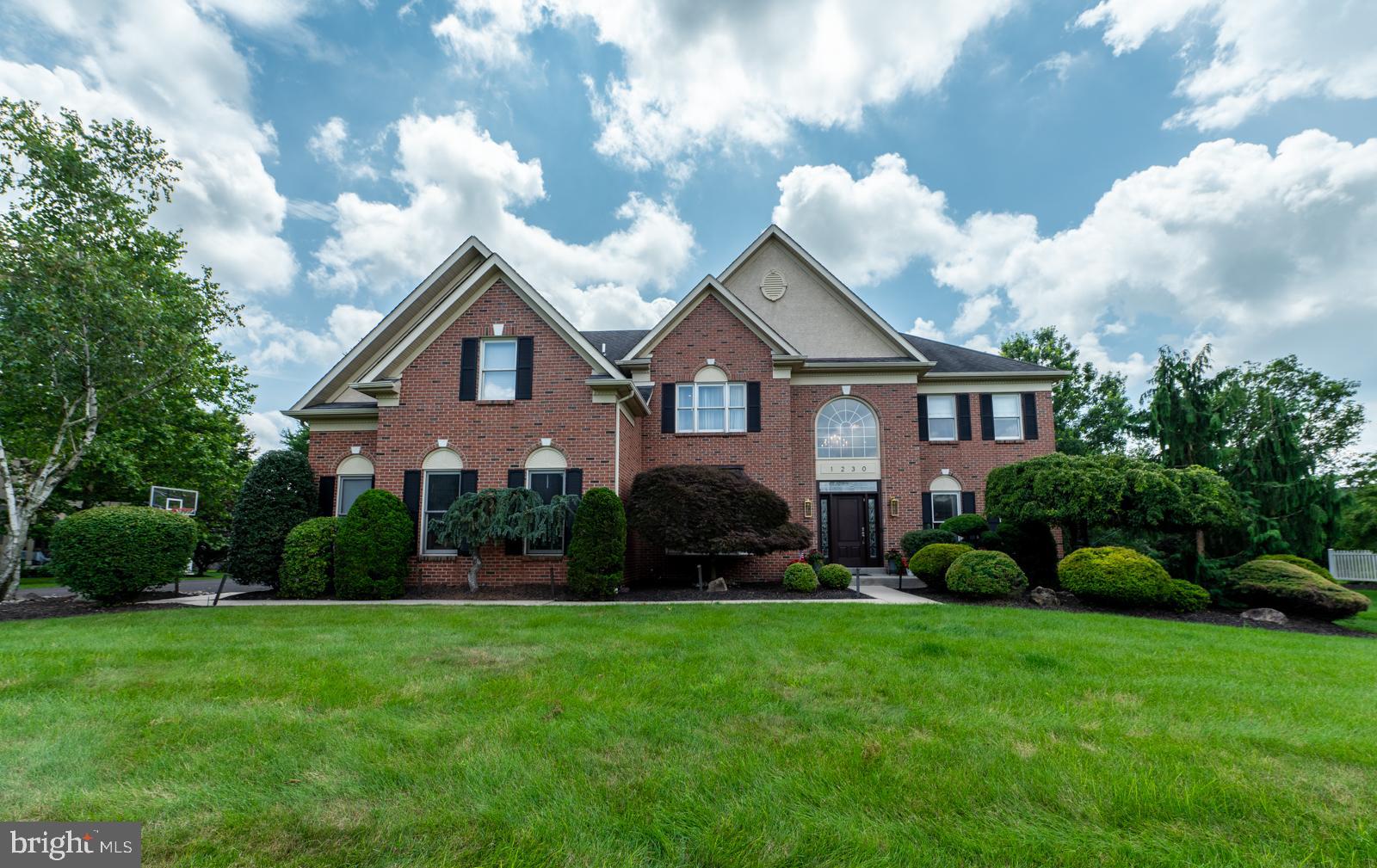 Elegant Brick-front Colonial, 4 bedrooms, 4 ½ baths, w/4,000+ sq ft of Refined Living space, situated on a Serene 59-acre lot in coveted Wissahickon School District. From the moment you step into the Sun-filled Foyer with Sweeping Grand Staircase, Custom woodwork and Gleaming Hardwood Floors, you’ll appreciate its timeless Sophistication. The Gourmet eat-in Kitchen is a Chef’s Dream, 5-Burner Gas Cooktop, Granite Countertops, Double Wall Ovens, Stainless Steel appliances, Walk-in Pantry, and Central Island which Invites gathering and effortless meal prep. Custom Sliding door opens to the Lush Treelined Professionally Landscaped Backyard featuring a large Trex Deck. The Open Floorplan flows into Stunning two-story Family Room, anchored by Floor to Ceiling Marble Gas Fireplace, Wet bar, Back staircase and Dramatic Wall of Windows. Spacious Living and Dining Rms are perfect for entertaining. Main Floor Study w/Glass French Doors with direct access Full Bath offers a flexible space. Powder Rm and Laundry/Mudroom complete the 1st floor. Upstairs the Luxurious Owners’ Ensuite w/Sitting area, Vaulted Ceiling, Expansive Walk-in Closet is sure to Impress - Fabulously Updated Spa Bathroom boasts - Oversized Seamless Glass shower, Relaxing Soaking Tub and Custom Vanities. Second floor includes – Nicely sized 3 Bedrooms, one of which is an ensuite and along w/hall bathroom. Conveniently located near Springhouse Village, Whole Foods, Starbucks, English Village, SEPTA train station, Rt 309, PA Turnpike and area Nature Trails.