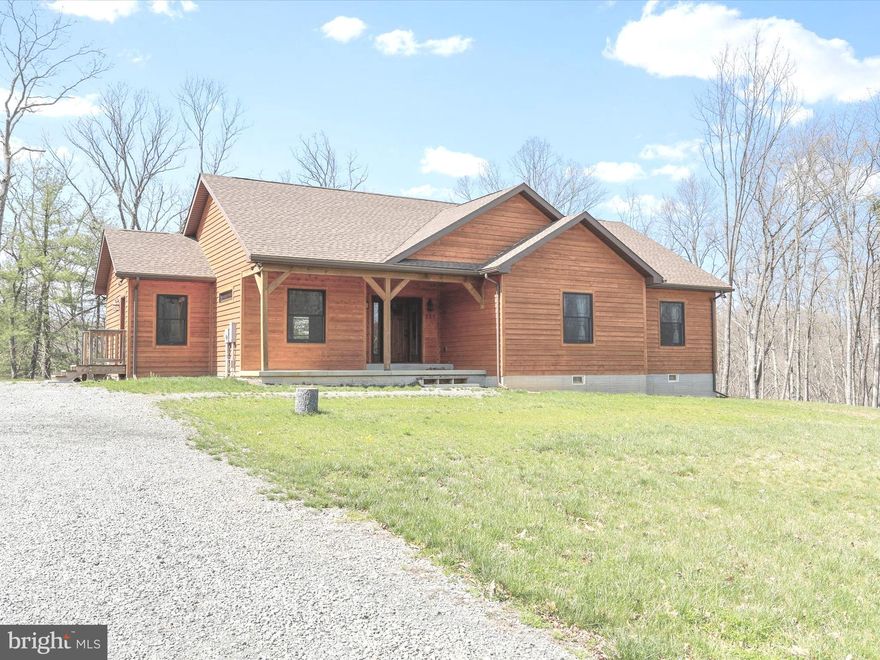 Nestled in the serene beauty of scenic Berkeley Springs, this 2023-built contemporary single level cedar home is more than just a house—it’s a dream come true.  
Very easy access to downtown Berkeley Springs, both Rt 522, or Rt 9 are just minutes away. Only 37 miles to Winchester, VA via Rt 522, just 27 miles to Martinsburg, WV via Rt 9, and only 16 miles to I70 at Hancock, MD.  Just a short drive to Cacapon State Park and Bathhouse, or the Sleepy Creek Wildlife Management Area which offers many activities for the outdoor enthusiast. So much to see and do! Perfect as a vacation or full time home. 
With 1,864 square feet of living space, on just over 2 acres,  strikes the perfect balance between spaciousness and intimacy. With three bedrooms and two baths, it’s ideal for anyone who cherishes comfort and modern design.
The home’s sleek lines and open floor plan bring a sense of flow and connection. Expansive windows flood the space with natural light. Inside, the blend of natural wood tones and clean, modern finishes creates a calming atmosphere. A wood burning fireplace and cathedral ceiling adorns the kitchen/living room area. The kitchen, equipped with stainless steel appliances and a large island, is not only functional but a joy for anyone who loves to cook—or entertain.
The master suite, complete with trayed ceiling, an ensuite bathroom with separate shower and tub. The additional bedrooms are generously sized, perfect for guests or perhaps a home office.
Outside, a large deck invites you to savor your morning coffee in a private setting where you can enjoy your time connecting with nature, loved ones, or even with only yourself.  
It's not just a house; it’s a lifestyle of peace, elegance, and mountain charm. Be sure to check out the video tab for a virtual walkthrough. Come on out and see if it's the one for you! You won't be disappointed.