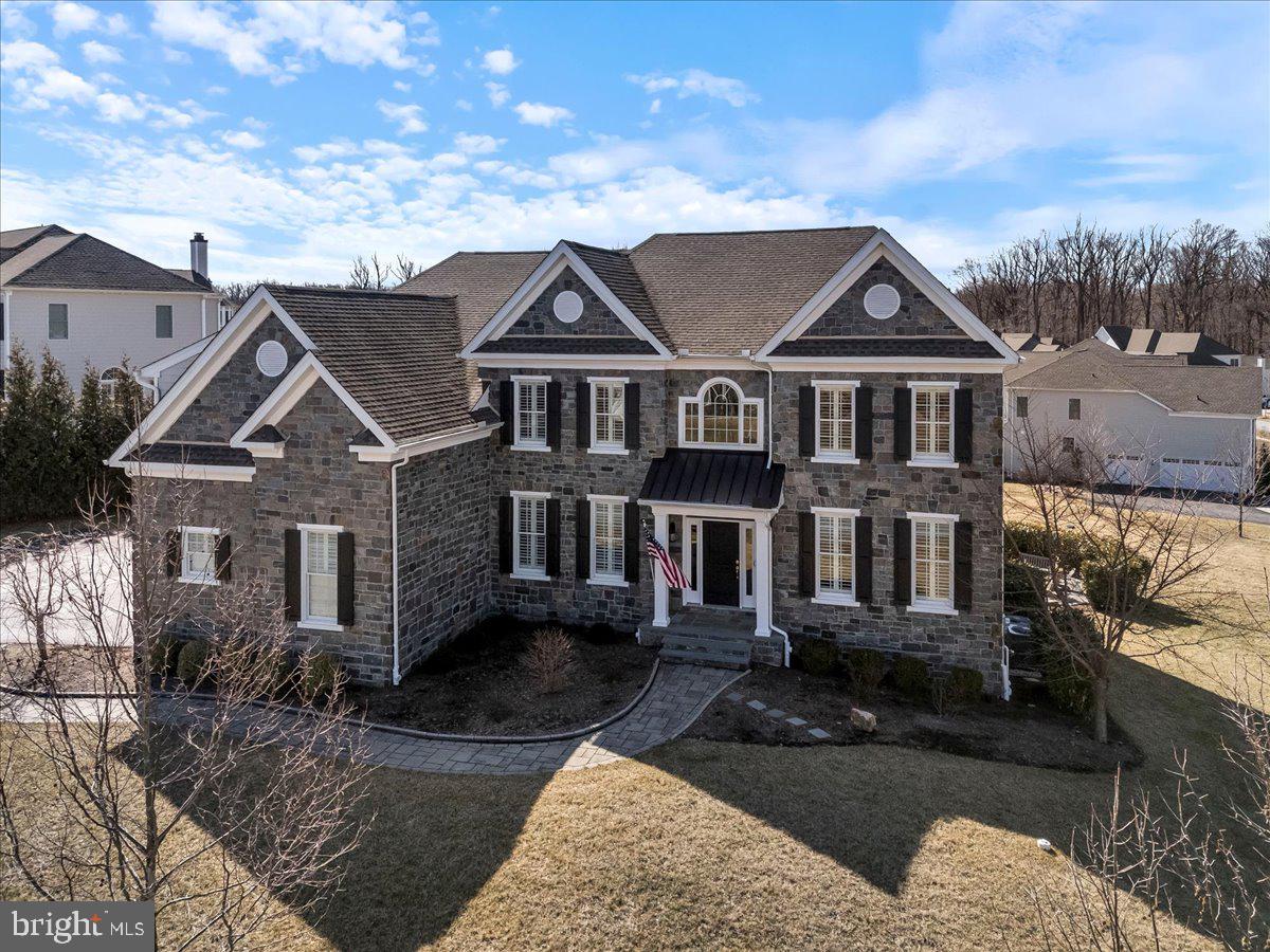 If you are looking for the perfect blend of modern luxury and functional opulence, look no further than 3905 Greenbank Ln.! An opportunity like this rarely becomes available in the exclusive Liseter Community! This expanded Langley II model home sits on one of the largest corner lots in the neighborhood, inviting you in with its beautiful stone front. As you step up the winding stone walkway through the covered front entry, you will be blown away by the stunning two-story foyer and grand staircase that greet you as you enter. On your right, the sitting room is the perfect spot to welcome your guests with stylish wainscoting, ample natural light, and gleaming Oak saddle hardwood floors that run throughout the first and second floors. Across the entry is the open-concept formal dining room which offers plenty of space to gather and make new memories, as well as extensive millwork and wainscoting that you will notice all throughout this incredible property. As you flow into the kitchen, your eye will be drawn to the dazzling white cabinets, custom tile backsplash, generous island with seating, and quartz countertops. With stainless steel appliances, gas cooking, and abundant storage space in the cabinets and pantry, your inner chef will be inspired like never before! Imagine enjoying a quiet meal in the breakfast area with a skylight overhead and views of the serene backyard. Sliders provide access to the rear deck and the stunning screened-in porch that is the perfect bug-free spot for relaxing in the warm weather. As you move into the family room, the two-story ceiling provides a dramatic feel to the inviting space which boasts many large windows that bring in natural light and a cozy fireplace to keep you warm in the winter months. A private office sits around the corner, as well as a half bath. The laundry room with utility sink completes the main level. Choose from one of the dual staircases or back staircase to bring you upstairs to the breathtaking primary bedroom suite. Your private oasis awaits as you enter into the comfortable sitting area which opens up into the spacious bedroom with tall windows and recessed lighting. As you make your way to the incredible en-suite bath, you will pass a total of three walk-in closets and a well-lit dressing area with storage. The bright and airy bathroom features beautiful tile floors, dual sinks, and a glass walk-in shower. Down the hall, the princess suite boasts an en-suite full bath and walk-in closet. Two more sizeable bedrooms and a full hall bath with dual sinks complete the upper level. Even more living space abounds in the finished walk-out basement with a convenient half-bath, media room, game room, flex space that’s currently set as a sitting room/bar, and ample storage space. All of this and so much more including hard wired surround sound speakers inside and out, hard wired security cameras, as well as a whole house water softener! Sliders lead out to the private gas-powered firepit where you’ll love roasting marshmallows and hanging out with your friends in the summer. The three-car garage and oversized driveway provide all the parking space you could need for yourself and your guests. As if this amazing home didn’t have enough to offer, the Liseter community amenities are out of this world, including a clubhouse, a carriage barn, swimming pool, sport courts (basketball, tennis, pickleball, bocce), gym, and walking trails. Enjoy quick access to the finest local shopping and dining establishments, Ellis Preserve, elite golf clubs like Aronimink, and nearby Marple Newtown schools. This incredible home has been meticulously upgraded using only the finest quality materials and craftsmanship available. Don’t miss out on this rare opportunity—schedule your tour today!