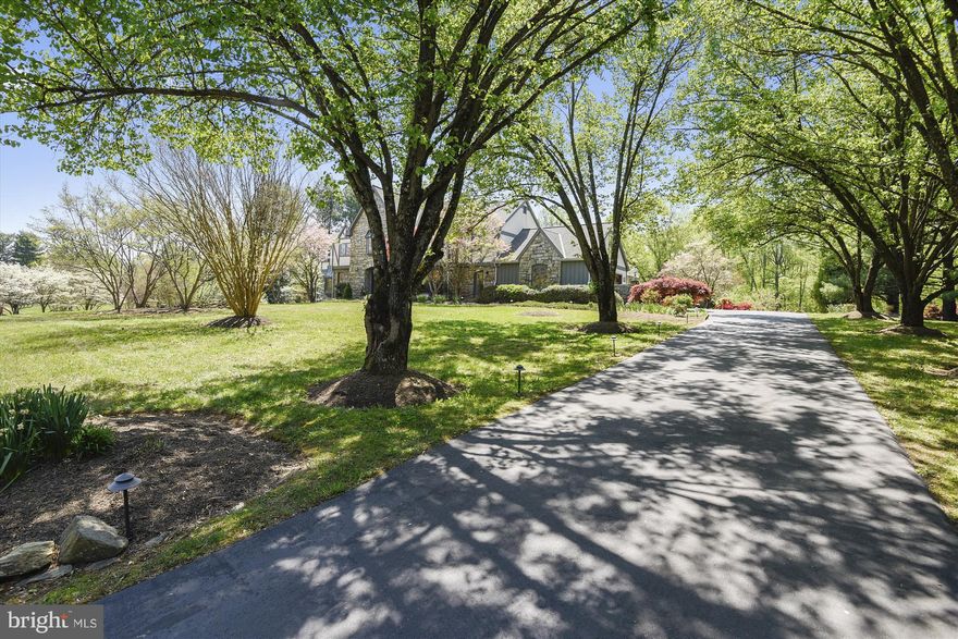 Spectacular custom designed stone & wood Tudor,sunny contemporary interior W/ open floor plan for entertaining.Overlooks lovely garden, flagstone patio under a wisteria-covered pergola,set on beautiful 2-acres. Sun-filled LR w walls of glass & stone FP soaring to cathedral ceiling. UL:MBR w sitting rm & MRB w jacuzzi (west wing), two additional BRs w bath (east wing), and guest BR, BA & backstairs