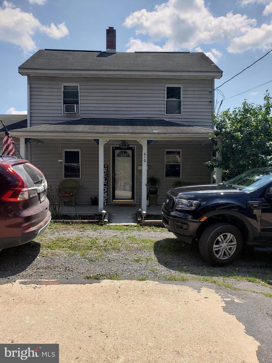 Older home within walking distance to downtown Berkeley Springs, large .25 acre corner lot.  Great for commuting on I-70 to Hagerstown/Cumberland.  Two, possibly three bedrooms and full bath on upper level, dining area adjacent to living room, large kitchen. and half bath. Attached garage for parking, or use for storage or workshop.  Full basement with inside access and outside rear access.  Plenty of space for gardening in the large backyard. Newer windows for easy cleaning, storm doors. This would make a great full time rental property or perhaps an airbnb/vrbo. Close to shopping, schools, hospital and commuting.