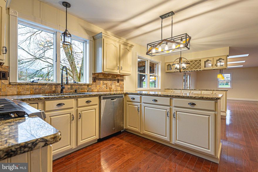 Experience understated elegance in this beautifully appointed 5-BEDROOM, 3.5-BATH, Colonial style home.    The main level welcomes you with a SPACIOUS FOYER that opens to an expansive LIVING ROOM featuring a GAS FIREPLACE with TV above, FRENCH DOORS TO A PRIVATE CONCRETE DECK, and a FRENCH POCKET DOOR connecting to the kitchen!   NEWLY PAINTED MAIN LEVEL and stunning WOOD FLOORS THROUGHOUT MAIN LEVEL elevate the overall sense of timeless style while the MULTIPLE SKYLIGHTS flood the space with natural light!   The WELL-DESIGNED KITCHEN impresses with GRANITE COUNTERTOPS, CUSTOM TILE BACKSPLASH, UPDATED LIGHTING, STAINLESS STEEL APPLIANCES, and a GAS RANGE ideal for the home chef.   The innovative "TAP-TAP" REFRIGERATOR is a thoughtful bonus!    A nearby STORAGE CLOSET can easily convert into a main-level laundry center for added convenience.   Flexible GREAT ROOM and DINING ROOM allow you to tailor the layout to your lifestyle! Convenient MAIN-LEVEL GARAGE ACCESS adds everyday ease.   The second level repeats the same flare with the PRIMARY BEDROOM, attached PRIMARY BATH with WALK-IN CLOSET, DOUBLE BOWL VANITY and the glorious RECIRCULATING HOT WATER!  Three additional bedrooms, FULL BATH with skylight and a double HALL STORAGE CLOSET kick this 2ND LEVEL into overdrive!  The NEWLY FINISHED LOWER LEVEL 38 X 25  REC ROOM will knock you socks off!  The BRAND NEW BASEBOARD HEATING keeps it nice and toasty!  The 5th BEDROOM and an additional FULL BATH are located on the lower level, offering great guest, in-law, or teen suite potential.   The Laundry/Utility/Storge Room can accommodate many uses!    You will also find ACCESS TO THE REAR YARD extremely convenient!   Step onto the 29x16 TREX DECK and CUSTOM PERGOLA—your new go-to spot for backyard hangouts, laughter, and HOT-TUB relaxation.   The EXTENSIVE LANDSCAPING AND HARDSCAPE around the property offer a peaceful, meditative  space to unwind!   My goodness, we haven't talked about the CONVENIENCE to Northrop Grumman, Schools, Restaurants, Shopping and I68!   Inside and out, this home is beautifully finished—truly THE COMPLETE PACKAGE!  This gem is sure to check all the boxes!  Call for an appointment to tour today!  (P.S.  The GAP Roofing System is about 3 years old and comes with a transferable 50 YEAR WARRANTY!!)