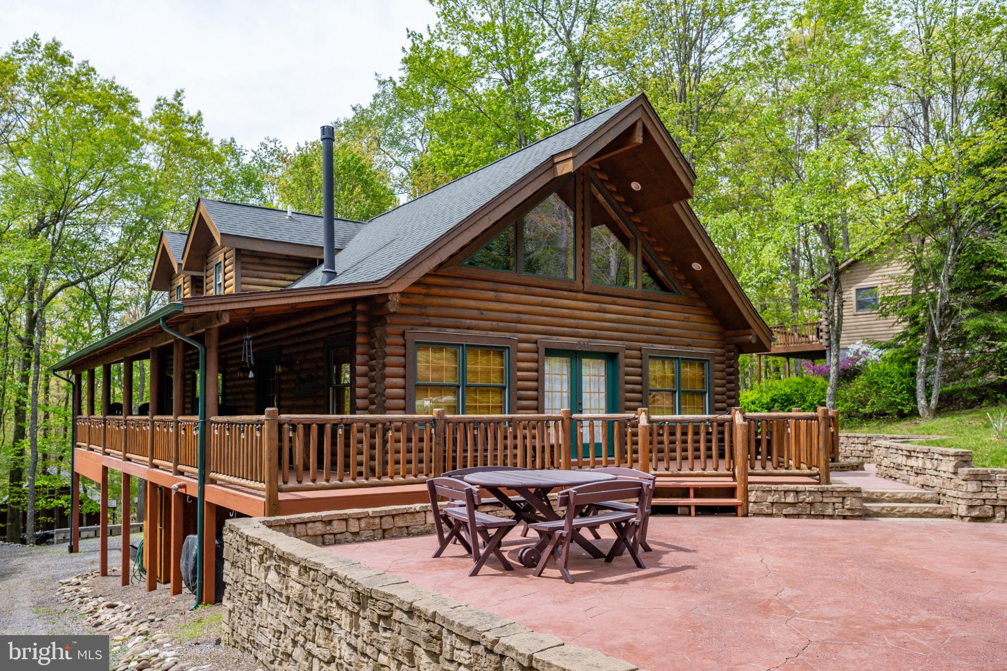 Welcome to 201 Deer Run Lane in Sky Valley! Just in time for summer, this 3BR/2.5BA log home offers cabin living at its finest in Sky Valley, one of Deep Creek Lake's most sought after lake access communities. An expansive outdoor patio awaits you providing excellent outdoor spaces to entertain guests. The main level offers a primary bedroom suite with large walk in closet, powder room, kitchen and living room with wood burning fireplace! The upper level offers 2 bedrooms with a full bathroom and loft area, great for extra sleeping space or remote office space. The lower level has a rough in for a third full bathroom and additional living area if desired. The lower level also has a single garage space which will fit most full size cars and SUV's, or your lake toys. Dock slip available through HOA waiting list. Looking for a fantastic home in Sky Valley at Deep Creek Lake? Call today to schedule your private showing - this one won't last long!