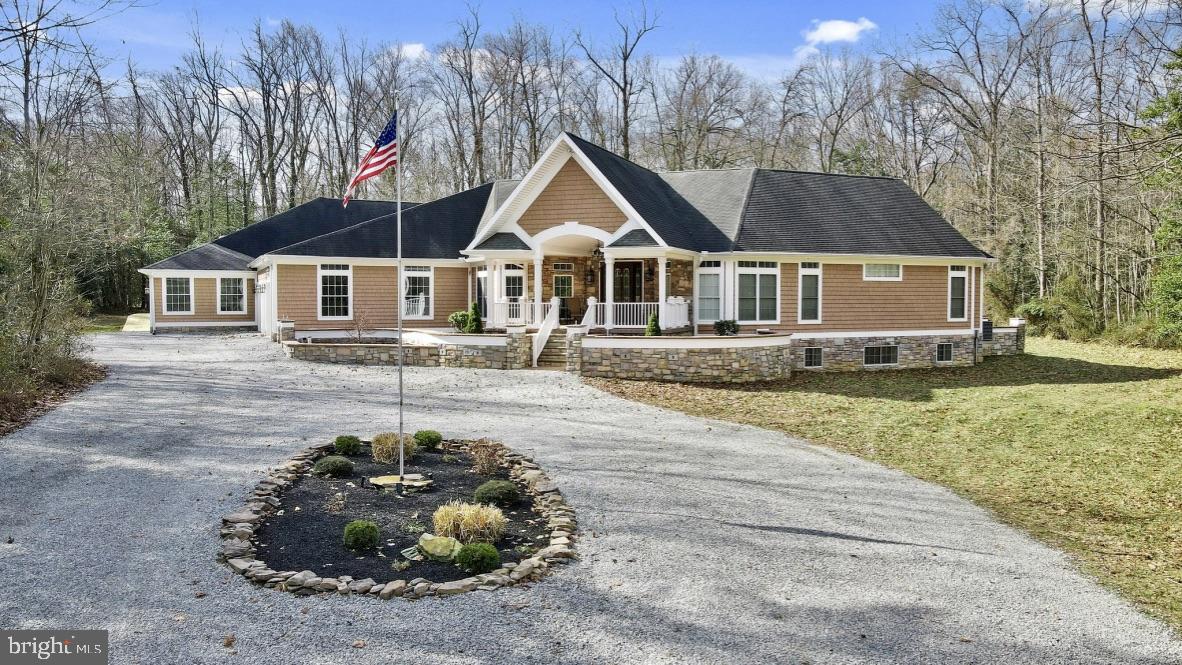 Entering this Custom Build Commercial Quality Multi-Generational Estate, you will find a grand entrance with porcelain tile and mahogany hardwood flooring and an open spiral staircase to the finished basement as you enter this custom-built home. This one-level estate will not disappoint with an open floor plan Gathering room, dining room, and Veranda. The primary suite has mahogany hardwood floors, stone stacked fireplace, private office space/or bedroom #2, dual walk-in closets, granite floors & countertops, heated tub w/jacuzzi, large walk-in steamer shower, and 2nd fireplace and sliders to the Veranda.
The Gathering area is a large spacious area for people to come together. This open space has a 20-foot tray ceiling, a massive stone-stacked fireplace, and several sliders open to the Veranda. Off this room is a laundry room with cabinet storage and a granite countertop, sink, and access to the garage. There is also a full bath with granite countertops and a porcelain tile shower. The dining room is heading toward the kitchen with extensive wainscoting and trim work that easily seats 20 guests with a granite-topped butler's pantry with a wet bar and sink.
Off the dining room is the South-West wing of bedrooms. This hall has a stand-alone full bath, an office space/bedroom, and three generously sized bedrooms, each with a private bathroom suite, walk-in closets, and sliders to the Deck and/or Veranda.
Walking from the dining room is the professional chef's kitchen with Black Cherry cabinets, granite countertops, three sinks, two dishwashers, a six-burner gas stove, four ovens, a trash compacter, two refrigerators, a large walk-in pantry, ice maker, wine cooler and warming drawer. Several areas of island seating are available, including seating for the littles and an eat-in breakfast area that looks out over the pond and has sliders to the rear deck.
Off the kitchen area, there is a second living room with a stone-stacked fireplace, a 2nd laundry area with garage access, and the MIL Suite on the home's south end. This ample living space has tray ceilings, a full bathroom with separate water closets, separate vanities, and a walk-in shower. This space also has a sunroom on the back with a mini kitchen with granite countertops, sink, and refrigerator. This sunny space enjoys the best views of the pond and wildlife with sliders to the deck.
Heading to the gathering room and out the sliders is the Veranda. The Veranda is a magical outdoor space to entertain and enjoy your guests with a 70 in flatscreen TV. Multiple eating and gathering areas include a stone-stacked wood-burning pizza oven, a stone wood-burning fireplace, and a cooking area with a dedicated propane line to the charbroil/flattop griddle & grill. There is also a vented hood exhaust system, sink, and refrigerator. This space is pre-wired & plumbed for an additional ice maker or wine cooler.
From the Gathering room to the open stairs and the finished basement. Downstairs is a 3rd living room area with a stone-stacked fireplace, dining room space, office space, bedroom, full bath, and full kitchen with granite countertops. There is also a Gym and a fantastic Theatre Room. As you head down the hall, there are lighted movie marquis leading you to the Theatre. There are nine electric theater seats with trays and power chargers. The Theatre is finished with granite and stone and a premium 85" QLED TV and Atmos movie theatre quality sound system.
The private drive has plenty of extra parking. With a turned 3.5 car garage perfect for the car enthusiast, pre-wired for lifts with extra concrete to support the weight. There are walk-down stairs to the finished portion of the basement from the garage. This home is wheelchair accessible from the front of the house, from the garage, and the rear of the MIL suite. There are also stairs from the 2nd living room off the MIL suite that go down to the unfinished part of the basement that has a chair lift.