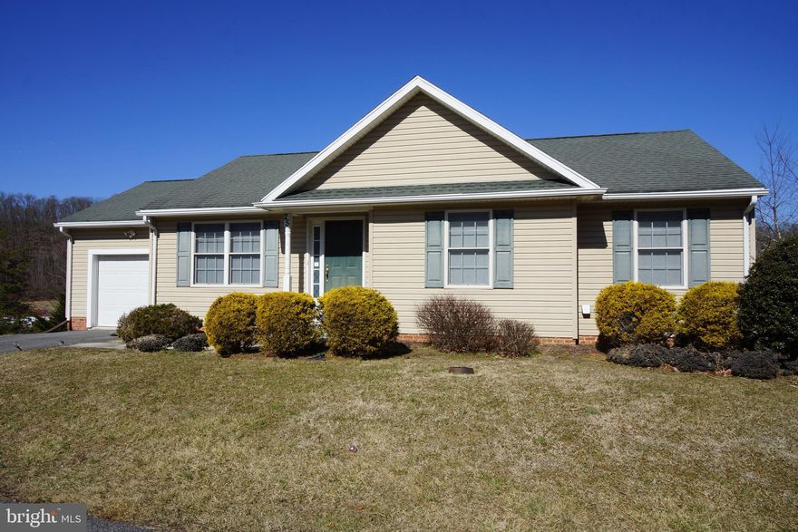 Excellent opportunity to own a spectacular home with amazing views!  Just a little TLC is needed to get this home back to it's full potential!  This rambler located on a cul-de-sac offers main level living with an open floor plan.  Hardwood floors throughout the family, dining, kitchen and hall with plenty of natural light.  3 Main level bedrooms, one currently used as an office & laundry,  yes, laundry on the main level!  The primary bedroom offers a walk in closet and full bath with walk-in shower and 2 vanities.  Dining area right off the Kitchen that offers an exit to the large deck, perfect for enjoying the sunset, grilling and spectacular mountain views.  The lower level walks-out to the backyard that backs to trees, offers a large rec room and another true bedroom, tons of storage and plenty of opportunity to expand the living area.   This home is located less than half a mile from the local grocery store and gas station and less than 5 miles to Route 70.  Don't miss this amazing opportunity! Short Sale professionally negotiated, must be willing to wait minimum of 90 days for bank approval.  Sold AS IS.