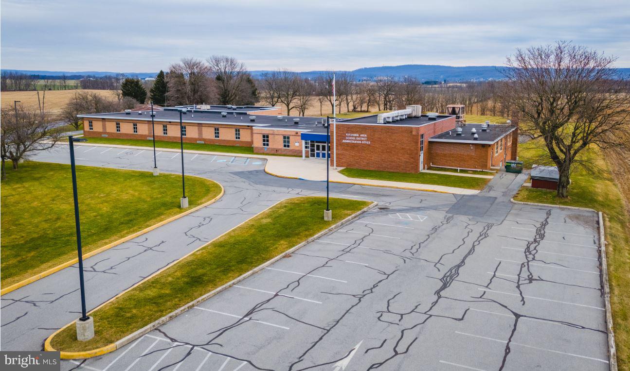 Berkshire Hathaway Fox & Roach Commercial Real Estate is proud to introduce 251 Long Lane Road in Kutztown, Pennsylvania. This property includes a structure of 19,708 SF on 6.6 acres and is located in Maxatawny Township.
This property long served as an elementary school within the Kutztown Area School District and currently functions as administrative offices. The building has been used continually and is very well maintained. It consists of approx. 20 private offices/classrooms, a gymnasium / cafeteria space, reception area, and a generous basement storage & mechanical area. It has abundant parking in front and rear and sits on 6.6 mostly flat acres. The property has a ‘School’ structure zoning type within the Commercial Zoning District and is located .2 miles from the nearest access to Route 222 where significant commercial and infrastructure development has occurred over the past 5 years.
This property offers many opportunities to make use of, or re-purpose the existing structure or for overall redevelopment given the favorable parcel characteristics. By-Right uses of interest in this Zoning District include Hotel, health Fitness / Athletic Club, Places of Worship, Veterinary, Business Offices, Medical, Self-Storage, and Assisted Living
251 Long Lane is located less than 10 miles from the Lehigh Valley, 1.5 hours to Philadelphia and less than 2 hours to New York City.