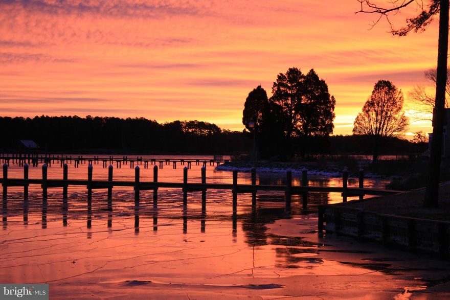 owners will consider reasonable offers.  Custom 2 story waterfront with master bedroom on main level.  Hardwood floors, 18 ft ceilings with tons of windows that show the awesome view!   Open floor plan features gourmet kitchen with breakfast bar, ceramic tile, corian counters & white/ red birch cabinets.  Den or gym on main level.  Oversized garage 27x20.  40x20 raised concrete patio.  165' pier.