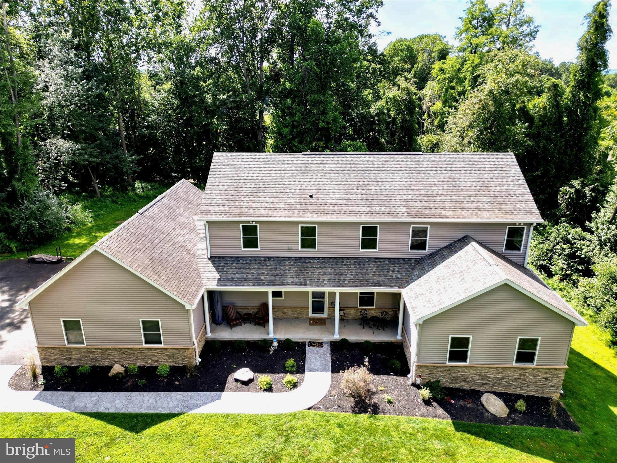 Welcome to 642 Craig’s Corner Rd, a gorgeous custom-built 5 bedroom, 3 bath Colonial on a serene 1.69 acre lot adjacent to the breathtaking Susquehanna State Park. As you enter, a welcoming foyer opens to an expansive living and dining room with 9’ ceilings, custom crown molding, and a bright, open floor plan with an abundance of natural light. The gourmet kitchen features a GE Monogram oven, microwave/convection oven, and induction range, along with a new GE Profile refrigerator and dishwasher. A breakfast nook and built in planning station add both charm and functionality. The main level also includes a 5th bedroom/office, a spacious family room perfect for gatherings, and a convenient main floor laundry. Upstairs, the spacious primary suite offers a spa-style bath with double sinks and a rainforest shower, with three large bedrooms and another full bath completing the upstairs. The amazing unfinished walk-out basement adds 1,800+ sq. ft. of potential. Enjoy outdoor living with a stamped concrete patio, new fire pit, and wooded views for privacy.
A Superior Walls foundation and state-of-the-art geothermal heat pump with HEPA filter provide structural integrity, energy efficient heating & cooling, and superior indoor air quality. The home is powered by two 200 amp electrical services, supporting robust energy needs, including the 50 amp Tesla charger in the 2 car oversized garage. Enjoy comfort, privacy, and efficiency in this custom-built retreat. No HOA, no restrictions. Truly a gem.