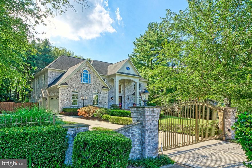 This extraordinary custom-built residence features four levels of luxurious living, spanning over 9,800 square feet of finely crafted space. Designed for both grand entertaining and private retreats, this home features six bedrooms, five full bathrooms, and two half bathrooms, along with five fireplaces that create warmth and ambiance throughout.

Main Level:
Step into a stunning two-story granite foyer with chandeliers, pendant lighting, wrought-iron railings, and sweeping arches that lead you to the formal and informal living spaces. A chef’s gourmet kitchen is the centerpiece, featuring granite counters, stainless steel appliances, and a large island that flows seamlessly into the dramatic two-story family room. A light-filled sunroom overlooks the expansive backyard and opens to a wraparound deck, perfect for al fresco dining. The formal living room shares a double-sided fireplace with the richly appointed library, creating a warm yet refined atmosphere. Hardwood floors run throughout, tying together each space with elegance.

Upper Levels:
The primary suite is a true retreat, featuring a private sitting area, fireplace, and a spa-inspired bath with a steam shower, large soaking tub, and separate glass-enclosed shower. Additional bedrooms include en-suite baths and generous closets. The top-floor retreat offers flexible space — whether as part of the primary suite, a guest retreat, or an additional lounge.

Lower Level:
The finished walk-out lower level is built for entertainment and relaxation alike. Highlights include a huge recreation room, theatre/media room, wet bar with lounge area, wine cellar, game room, and dedicated exercise space. With two bedrooms, one full bath, and one half bath, this level can easily accommodate long-term guests or extended family.

Outdoor Living:
The property boasts an incredible, fully fenced backyard designed for play, privacy, and entertaining. A large patio with an outdoor fireplace overlooks wooded surroundings, offering a serene backdrop for gatherings year-round.

Additional Features:
Schonbek chandeliers and pendant lights
Gated entrance to the driveway
3-car garage with ample storage
Elegant arches and architectural detailing throughout
Flowing open floor plan perfect for large-scale entertaining

Location:
Nestled in the heart of Great Falls, this home offers convenient access to I-267, I-495, Tysons Corner, and the Silver Line Metro — providing easy connectivity for commuters into D.C. while maintaining the privacy and tranquility of a Great Falls setting.

This home combines size, elegance, and thoughtful design with a backyard built for entertaining. With over 9,800 square feet, a sun-filled floor plan, and a wealth of modern amenities, it is a rare offering that defines luxury living in Great Falls.