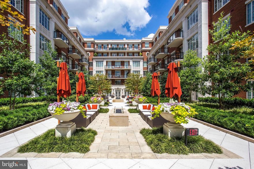 Welcome to The Signet, McLean’s premier luxury condo building, perfectly situated in the heart of the new-town streetscape. This exceptional location places you just blocks from downtown McLean’s vibrant retail and dining scene, minutes from Georgetown and DC, a little over a mile from the Silver Line Metro, and only three miles from Tysons Corner. This spacious third-floor unit features two generously sized bedrooms—each with its own balcony overlooking the serene Signet Park at Elm Street—along with two elegant bathrooms and walk-in closets. Beautiful hardwood floors extend throughout the open-concept layout, which showcases a stunning gourmet kitchen with a large island, top-of-the-line appliances, and seamless flow into the dining and living areas. Additional highlights include two reserved parking spaces in the secure garage (Spaces 297 & 298).The Signet features lots of amenities including a grand lobby entrance with full-serve concierge, beautifully landscaped courtyard with 4 lounge areas offering: tables, fire pit area with seating, Trellis-covered outdoor bar and grilling area with sink, fridge and dining tables. There is a clubroom, fitness center, sauna, steam room, massage room, fitness trail, pet spa & much more! The new home of McLean Project of the Arts will be ready by end of the year in the Rotonda with small coffee shop.