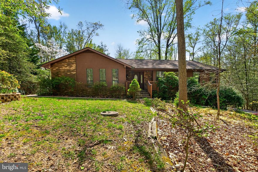 Spacious 3-bedroom, 2.5-bath home tucked away on a private wooded, secluded lot! Features a huge family room with a cozy fireplace, perfect for relaxing or entertaining. Enjoy the large enclosed porch for year-round outdoor gatherings. Generous-sized bedrooms, recently updated bathrooms, to include handicap accessible bath tub . Also, a convenient main-level laundry room add comfort and style. Massive 4 car garage offers endless storage or workshop space. Unfinished basement is ready for your personal finishing touches. A rare opportunity with space, privacy, and potential!