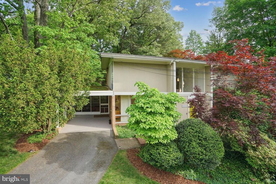 Fantastic mid-century modern home designed by renowned architect Charles Goodman. Spanning 3 levels, this sun-drenched home has an open floor plan with architectural elements throughout. The main level features a grand foyer with built-ins, a spacious living room, dining room with floor to ceiling windows, charming wood-paneled family room, and an eat-in kitchen with an attached screened in porch. The upper floor has four sizable bedrooms and two full bathrooms. The lower level has a large recreation room and a half bath. Lastly the home is complete with an attached carport and a beautifully landscaped yard.