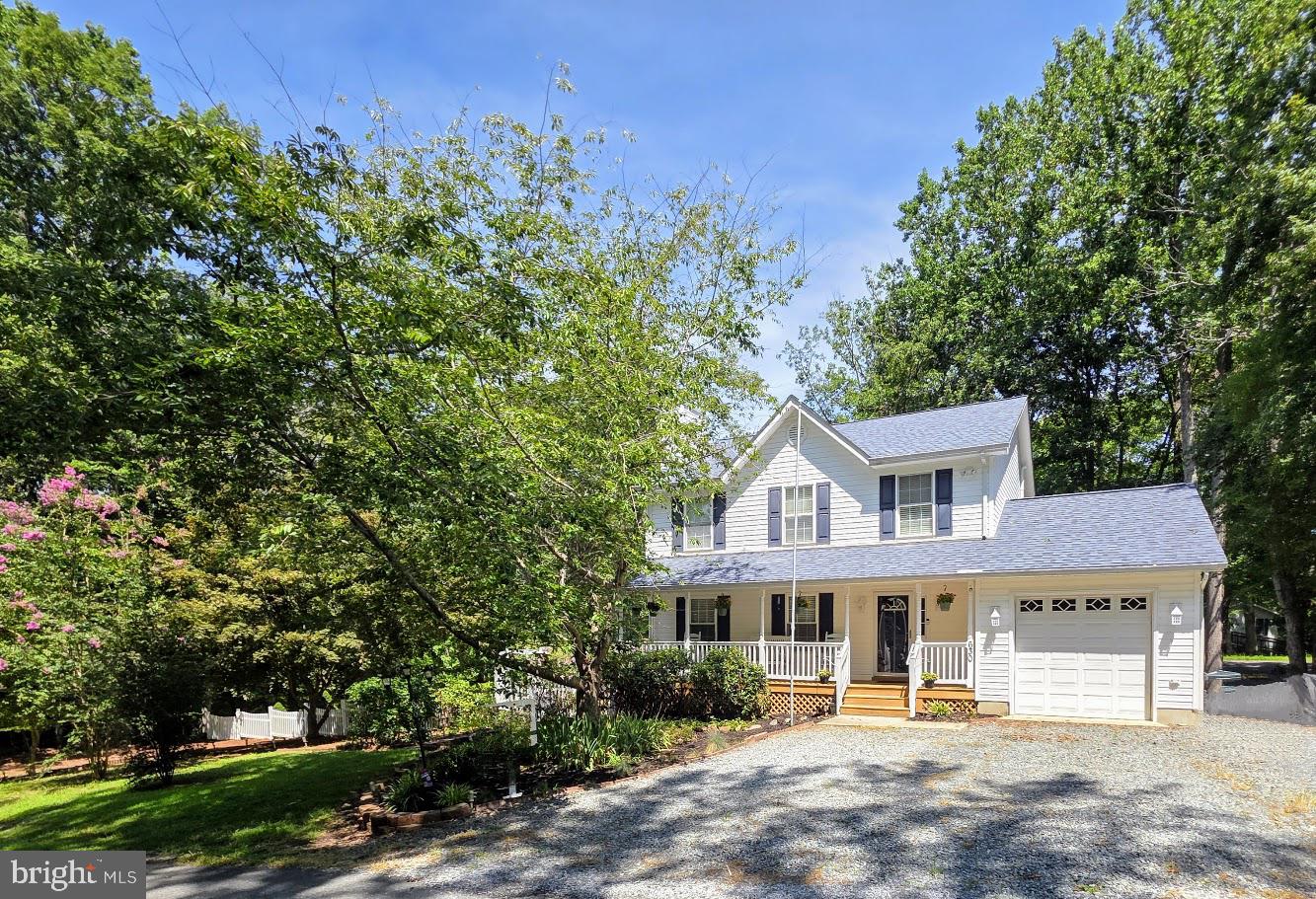 BEAUTIFUL LAKE FRONT HOME!!! Convenient location to Patuxent River NAS main gate with an approximate 35 minute commute! Only a short walk thru the woods to the Lake, this 1.4 acre property offers endless opportunities, serenity & privacy! Perfect for cookouts & get togethers! Looks Amazing with FRESH PAINT & NEW CARPET!!! New Stainless Steel Kitchen Appliances on order and will be installed very soon!!! Home Features a Cozy Front Porch * Main Level Features: Entrance Foyer with Hardwood Flooring & Crown Molding - Living Room with Hardwood Flooring, Crown Molding, Fireplace & Built-In - Dining Room with Chair Rail Molding, LVT Flooring & French Door to Deck – Kitchen with Oak Cabinets, Built-in-Desk, Pantry, Newer Deep Sink & Garden Window - Laundry Room with Washer and Dryer, Built-in Shelves, Separate Sink - Powder Room * Upstairs you have 3 Bedrooms which includes the Primary Bedroom with a Walk-in-Closet & Primary Bathroom with a Large Jetted Tub, Ceramic Tile, Double Sink & Separate Shower - Hall Bath * In the Lower Level you have a Spacious Rec Room with Ceramic Tile Flooring and a small Wet Bar/Kitchenette with Cabinets, Sink, Refrigerator & separate Freezer (which could be used as a 4th bedroom if needed) - Safe Room/Den -Full Bath with Shower - Patio Door to Hardscape Patio & Side Yard * Deck * One Car Garage with Pull Down Stairs to Attic * Nicely Landscaped with lots of beautiful flowers & flowering trees * Generac hookup in Garage with a Portable Generator as-is * Also has been updated with a New: Garage Door, Roof with 50 year shingles, Leaf Gutters with transferrable warranty, 80 Gallon Hot Water Heater/2years, Crown Molding, HVAC/3 years ** On Lake Lariat you can enjoy Fishing, Swimming, Boating, Canoeing, Kayaking! Not far from Solomons Island, Patuxent River, Chesapeake Bay, Shopping & More! SELLER OFFERING $3000 BUYERS CLOSING HELP WITH AN ACCEPTABLE OFFER