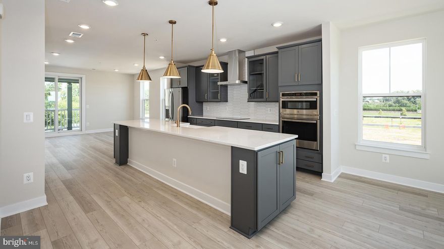 **Up to $30K IN FLEX CASH WITH USE OF APPROVED LENDER AND TITLE! Lower your price, cover your closing costs, or buy your rate down** 
Step inside the Clarendon, where thoughtful design and stylish finishes come together in every room. Enter through the welcoming front door or enjoy the convenience of access through the private rear garage—both leading into the main living level. At the heart of the home, the gourmet kitchen shines with gray cabinetry accented by elegant gold hardware, complemented by designer pendant lights over the oversized 12' island. An upgraded induction cooktop and walk-in pantry complete this chef-ready space. Just beyond, the dining room flows seamlessly into a spacious great room that opens to a covered lanai, ideal for indoor-outdoor living. Upstairs, the primary suite offers a private retreat with an expansive walk-in closet and a spa-inspired bath featuring gold fixtures, and a ceramic-tiled walk-in shower with seat. Two generously sized secondary bedrooms share a full hall bath with neutral white cabinetry, upgraded ceramic tile, and gold hardware. A full-size washer and dryer are conveniently located on this level. Then make your way up to your expansive rooftop terrace with private tree views.