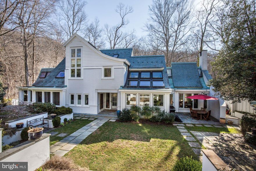 NEW PRICE!!! 7000+ SF home in resplendent parkland setting w/ spectacular privacy! Open, airy, & sun-drenched throughout w/ countless skylights & serene, leafy vistas from every window. 5BR main house w/ Kit/Fam rm, media rm, screened porch & gorgeous surrounding gardens plus detached carriage house w/ 2-car garage & studio ste above. Turnkey renovated w/ many green features!