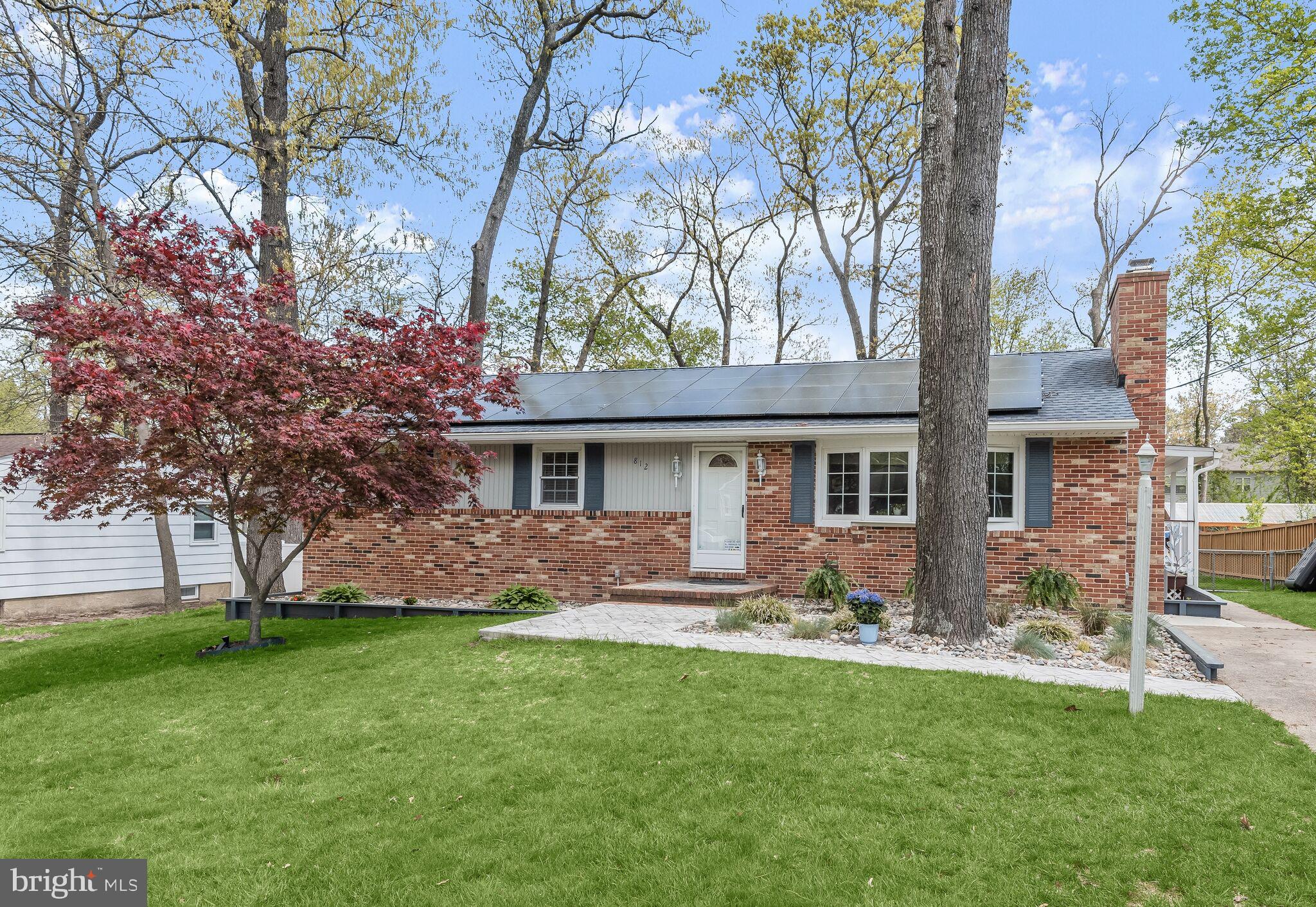Discover this beautiful ranch-style home located in the desirable Danza Village community, boasting updated interiors, situated on over a third of an acre level lot, and complete with a charming screened porch for outdoor enjoyment. Step through the stamped concrete walkway, surrounded by serene landscape design leading to the foyer. Inside, the spacious living room welcomes you with a bay window, cozy brick accented fireplace, and recently refinished hardwood floors that extend throughout the main level. The eat-in kitchen features white upper cabinets and gray lowers with roll-out shelves, stainless steel appliances including a wall oven, and granite counters. A sliding glass door opens to the 16x16 screened porch with a cathedral ceiling and skylights, offering panoramic views of the backyard. Retreat to the primary bedroom boasting two closets and a renovated en-suite bath with a timeless floor-to-ceiling subway-tiled shower. Two additional bedrooms and another full bath complete the main level. The lower level family room offers a versatile space for relaxation and entertainment. The lower level also hosts a fourth bedroom, and a renovated laundry room with design-inspired tile flooring and recessed lighting. Additionally, a lower level workshop with walkout stairs to the backyard awaits your projects. Outside, the sprawling fenced backyard features a 12x12 shed with electric and a wraparound deck, providing ample space for outdoor gatherings and activities. Convenient access to major highways, Fort Meade, BWI Airport, and a plethora of shopping, dining, and entertainment options ensures an effortless lifestyle. Experience comfort, style, and convenience in this Danza Village gem. Property Updates: Kitchen cabinetry painted, re-hung and aligned, replaced cooktop & microwave, septic tank & system, laundry room floor, lighting & machines, refinished hardwoods, white oak hardwoods, main level interior paint, primary bath renovation, light fixtures, deck stair, hardscaping, and more.