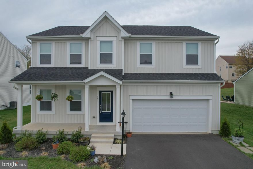Welcome home! Step onto the inviting covered front porch and into a beautifully designed open-concept main level featuring 9-foot ceilings that create a bright, airy atmosphere throughout the family room and kitchen. The stunning kitchen offers a spacious pantry, cozy breakfast nook, and flows seamlessly into a light-filled sunroom—perfect for everyday living and entertaining.  A versatile flex space on the main level provides the ideal spot for a home office, playroom, or additional living area to fit your lifestyle.  Upstairs, retreat to the spacious primary suite complete with a private en-suite bath and a large walk-in closet. Three additional bedrooms, a full hall bath, and the convenience of a second-floor laundry room complete the upper level.  The finished basement adds even more living space, featuring a lower-level powder room—perfect for guests, recreation, or a home gym.  This home offers the perfect blend of comfort, functionality, and modern design—ready for you to move right in!