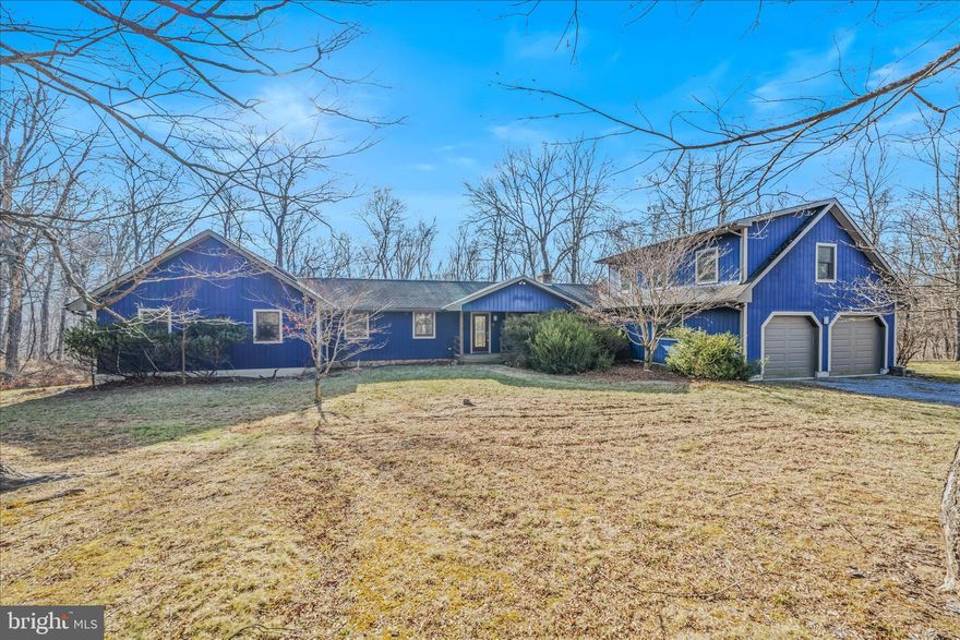 STUNNING RIVER FRONT RETREAT! This contemporary home fronting the Cacapon River features gorgeous hardwood floors, vaulted ceilings, skylights, sliding glass doors, and large windows, just to name a few of its attributes. The spacious living room features a wood burning stove and one of the three accesses to the large back deck where you can take in views of the Cacapon River; you can also access the screened in porch, a perfect place to have an evening meal or enjoy a cup of coffee in the morning. Just off the living room you will find a nook that is flooded with natural light, a perfect place to curl up with a book or just look out to the river. The kitchen has tons of storage to include a large pantry. Off of the kitchen you will find the large laundry room and beyond the laundry room is the mudroom from which you can access the two-car garage. Down the hall from the living room you will find a full bath, two bedrooms, and a den with another sliding glass door access to the large back deck. At the end of the hall is the spacious primary suite complete with hard wood floors, vaulted ceilings, sliding glass doors leading to the back deck, large windows, a separate room that could be an office or maybe even a nursery depending on your needs, a walk-in closet as well as a linen closet, and an ensuite bathroom complete with a shower and jetted soaking tub. Above the garage is a bonus space perfect for guest; this space includes a full bath and covered porch/balcony with views of the Cacapon River. With a pet washing station in the garage and a fenced in area of the backyard that can be accessed from the mudroom off the garage, this river front retreat is move in ready for your family of both the two- and four-legged nature. Whether you are looking for a full-time residence or an escape from everyday life, this home truly has it all!