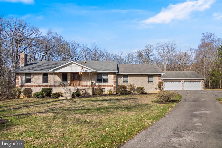 Updated home, nearly 3 private acres, and room for everything—welcome to this beautifully refreshed brick home in Marbury.

Freshly refinished hardwood floors, fresh paint throughout, brand-new stainless steel kitchen appliances, and new carpet in the finished basement make it truly move-in ready.

The main level offers three bedrooms, including a primary bedroom with private bath, along with comfortable living and dining spaces and a centrally located kitchen designed for everyday living. A laundry area with half bath near the garage entry adds practical convenience.

The walk-out basement significantly expands the living space, featuring a striking floor-to-ceiling brick fireplace, an additional bedroom, full bath, kitchenette area, and flexible space ideal for a recreation room, guest suite, or home office.

A spacious rear deck overlooks the peaceful, tree-lined property—perfect for morning coffee, evening gatherings, or simply enjoying the privacy of nearly three acres.

The property includes a two-car attached garage plus a detached four-car garage, offering excellent space for vehicles, storage, hobbies, or workshop use.

Conveniently located just minutes from Naval Support Facility Indian Head and a short drive to downtown La Plata’s restaurants, shops, and community events, with access to National Harbor, Joint Base Andrews, and the greater Washington, DC region.