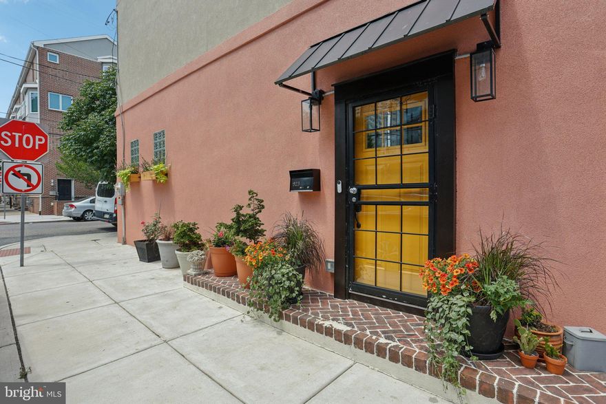 Welcome to 923 S 3rd Street—a hidden gem at the entrance to one of Queen Village’s most picturesque blocks. With its front door tucked along the quiet charm of Montrose Street, this beautifully updated home blends timeless character with modern design, just minutes from some of the city's top attractions. A welcoming tiled foyer opens into a spacious open-concept main level. Natural hardwood floors lead through the bright and stylish kitchen, featuring quartz countertops, stainless steel appliances, an imported glass tile backsplash, breakfast bar, and abundant cabinetry. The open dining and living areas enjoy high ceilings, layered lighting, and oversized energy-efficient windows that bring in great natural light. Out back, a private and fully enclosed patio offers a tranquil outdoor retreat. The second floor includes two well-sized bedrooms with ample closet space and large windows, as well as a full bath in the hall. The entire third level is dedicated to a spacious Primary Suite- a true sanctuary with dual exposures- complete with custom built-ins, two closets, and a full ensuite bath. The finished lower level adds valuable flexible living space—perfect for a media room, home gym, office, or guest area. A tucked-away laundry nook and fully waterproofed foundation, along with a whole-house surge protector, offer both function and peace of mind. Located in the highly desirable Queen Village area, this home offers convenience to parks, Penn’s Landing, museums, boutiques, cafés, and the nearby Mario Lanza Dog Park. 923 S 3rd Street offers the perfect balance of historic charm, contemporary upgrades, and an unbeatable location—ready for you to enjoy.