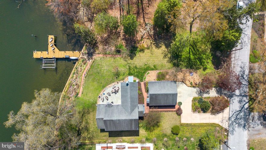 Welcome to your own piece of paradise! This stunning waterfront home boasts 180' of direct water frontage, a deep water private pier with extra pilings installed to accommodate mooring for up to three boats, a boat lift and your own private beach perfect for waterfront enthusiasts. Enjoy breathtaking water views from nearly every room, including the sunroom, kitchen, family room, primary bedroom, and upper-level bedroom. The bright and beautiful interior features windows galore, allowing natural light to flood the home.

With over 3,000 square feet of living space, the main level offers a spacious bedroom with a full bath and a cozy fireplace in the family room for those cool evenings. The expansive stone patio is ideal for entertaining or relaxing while overlooking the serene water. The home has been meticulously renovated since 2017, with extensive updates throughout. The main structure was completely rebuilt in 2000.

All four bedrooms feature ensuite bathrooms for ultimate privacy and comfort. Additional highlights include a 2-car garage, expanded circle driveway, and beautifully landscaped grounds. With a large lot and a secluded setting, this home offers tranquility and privacy. No flood insurance is required.

Homes like this don't come on the market often—don't miss your chance to make it yours! A full list of recent improvements is available upon request.