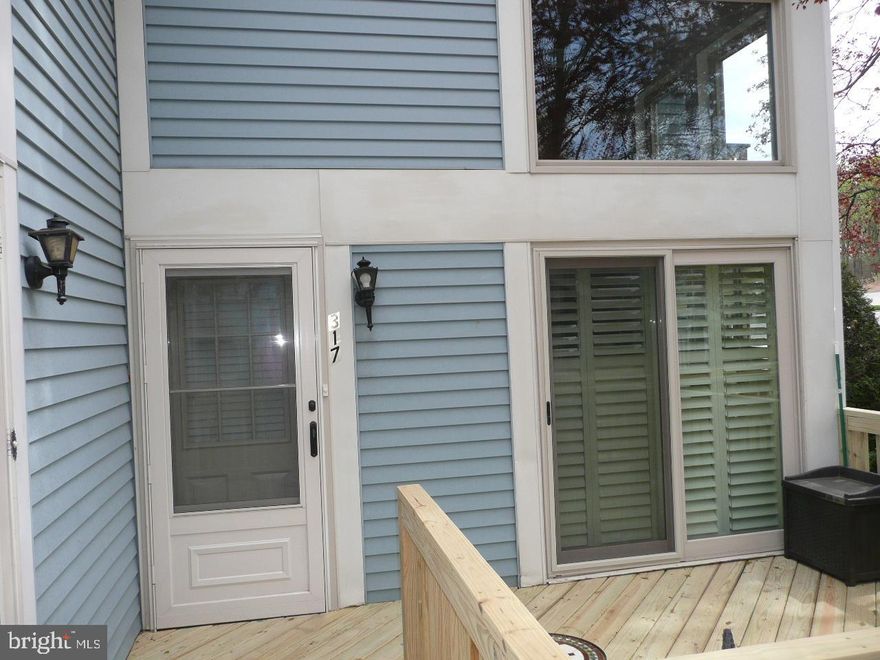 Beautifully maintained and recently updated first floor two bedroom one bath condo with wood flooring throughout.  Wood burning stone fireplace in living room with planked ceiling.   Updated kitchen with stainless steel appliances.   Replacement windows throughout.  Newer hall bath.  Brand new front wood deck.  Main bedroom with walk-in closet.  Easy to show.