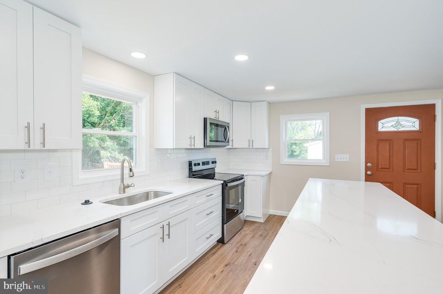 This beautifully remodeled raised rancher in Charles Town, WV, combines modern elegance with everyday functionality. Featuring three spacious bedrooms and three full bathrooms, this home offers a fresh, inviting atmosphere with newly painted walls and sleek LVP flooring throughout. The updated kitchen is a highlight, showcasing stainless steel appliances, new cabinets, and stylish countertops. The main floor includes three comfortable bedrooms and two well-appointed bathrooms, while the lower level provides an additional full bathroom, and a versatile flex room ideal for various needs. Additional features include a two-car garage, new vinyl siding, and a covered front porch. The expansive back deck, accessible from both the kitchen and primary bedroom, is perfect for outdoor entertaining. Conveniently located near shopping, dining, and major commuter routes like Rt 9 and Rt 340, this home offers a perfect blend of modern upgrades and practical living.