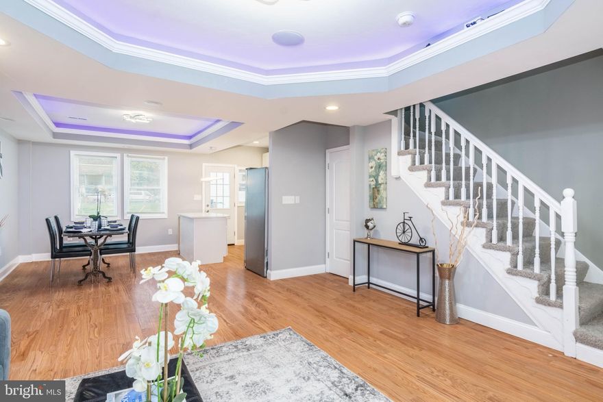 SPECTACULAR END OF GROUP RENOVATION FEATURING AN OPEN FLOOR PLAN AND 3 FINISHED LEVELS!  Features include hardwood floors throughout the main level, spacious living room with tray ceilings with rope lighting, separate dining area,  designer kitchen with granite counters, ss appliances, and tile backsplash, upper level with 3 bedrooms and 1 full bath, finished basement with a family room, 4th bedroom, and 2nd full bath.  Pack your bags and move right in!