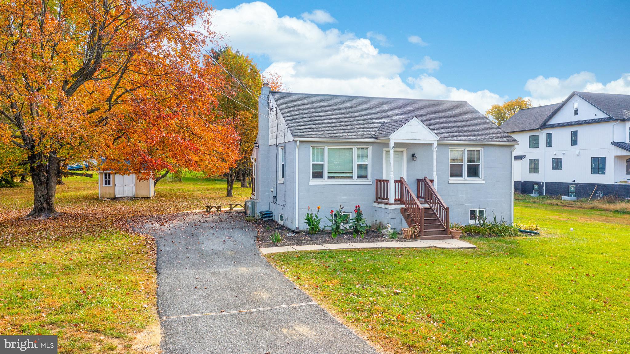 Rare find. Almost one acre flat and rectangular yard, a significant premium in an area where typical lots are about half this size. This charming ranch style home is a treasure for investors, first-time buyers, or small business owners seeking both comfort and convenience. Step into a world of warmth and comfort as you enter the light filled living room, perfect for entertaining or simply unwinding. The updated large eat-in kitchen featuring 42" cabinetry, fairly new appliances, and an exiting door to the serene backyard, invites you to craft and enjoy culinary delights. Rich wood floors extend across the entire main level, adding a touch of elegance and ease of maintenance. Upstairs, an unfinished attic space awaits your creativity – transform it into a private office, studio, or extra storage. The house also features a new roof and has been freshly painted with neutral colors, ensuring a move-in ready experience. The finished basement, with its own separate entrance, offers additional living space or the potential for rental income. Outside, the natural trees create a peaceful backdrop for summer BBQs on the wood deck, while the large storage shed caters to all your outdoor needs. With no HOA and zoned R20,​ public water and sewer, the possibilities are truly endless. The expansive driveway can easily park 6+ cars. Located near key routes and just minutes from Columbia and Ellicott City's vibrant communities, this home is a convergence of lifestyle and opportunity. Don't miss the chance to own this gem in a sought-after location, where space, freedom, and potential coexist in perfect harmony.