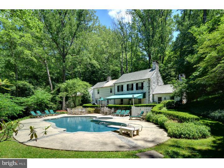 Classic True Walter Durham Colonial that is on 3.46 beautiful acres in the heart of the Gladwyne area that has all the charm of a Durham Colonial. You start your tour on the private driveway and parking area above the two car garage area. A short walk on the stones lead you to the front door as you open it you see a clear view through the home to the back patio and pool area and privacy of the backyard trees. To the L is a formal living room with FP and built in's the first thing you notice is all of the lighting features built in this home for the highlights you will love. There is a family room/den with unique built in bar, large colonial formal dining room with FP and Dutch Doors to the back patio. The updated kitchen includes Rutt Cabinets,concrete counter tops, sub zero refrigerator, Bosch dishwasher, double ovens, Viking gas stove top eating area, OE to back porch and back stairs to the upstairs from the kitchen. Also on the first level is a Den/TV room, 4th bedroom and full bath perfect for quests or Au Par suite. The second floor includes a wonderful walk in dressing area for master bedroom with full wall closets, updated and unique full bathroom and classic main bedroom. There are 2 other nice sized bedrooms on the second floor that share a bathroom and a nice sized bedroom with a full private bath. Other interior highlights of this home are the classic fireplaces, built in's,recessed lighting throughout the home, wainscoting with arched lighted built in's just charm everywhere you look. Then proceed to the private backyard that includes a hugh patio covered with a full awning, step down on flagstone to the in-ground pool that also has a built in hot tub and large trees surround the pool with extensive landscaping lighting system throughout to add that touch of class in the evening nights. There is a 2 car attached garage and shed and pool house on the property. This home dates back to 1934 with additions/updates in the 1980's. If you are looking for a classic Main Line Durham Colonial you need to take a look at this estate and make it your next home for your family.
